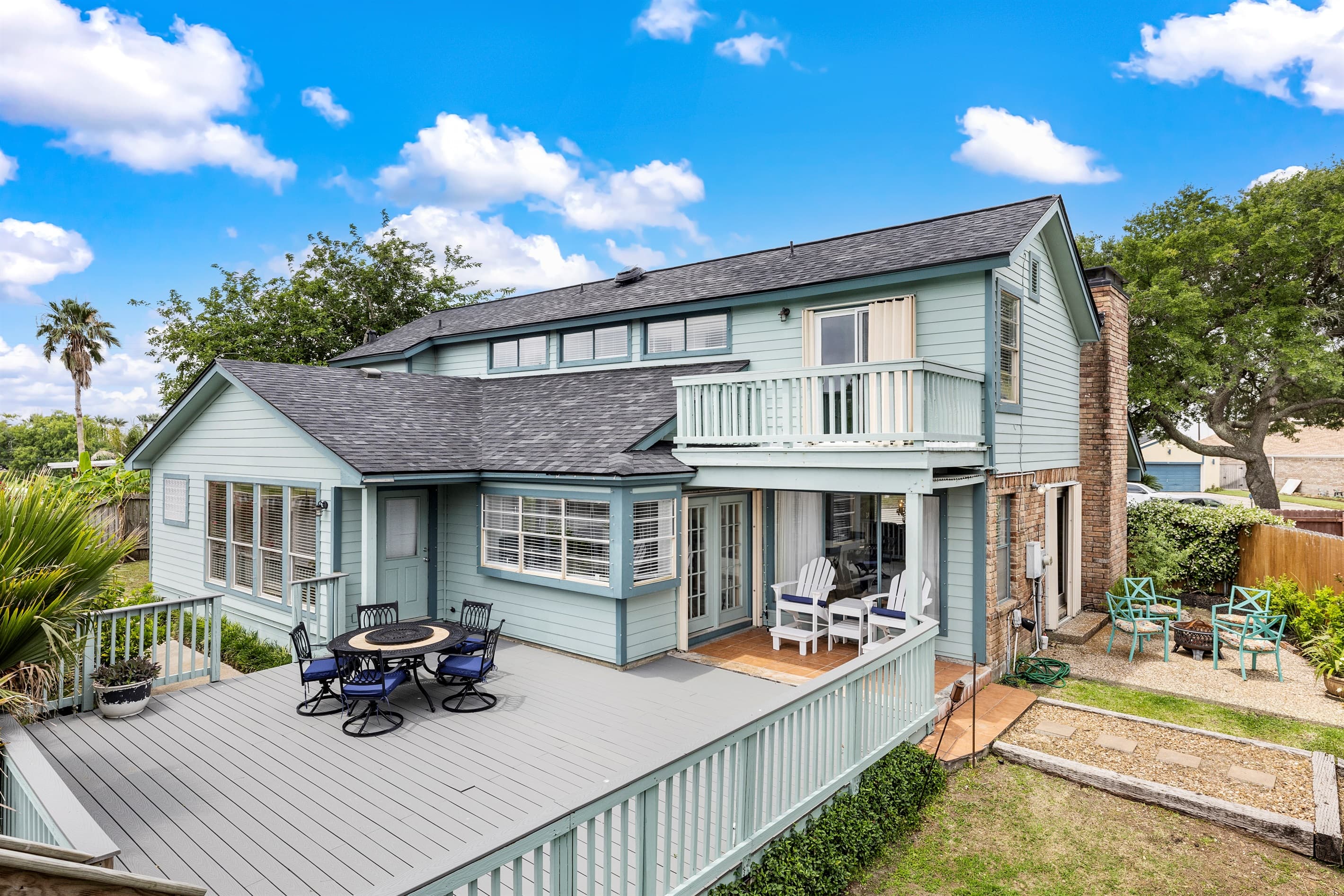 Lakeview Landing from the waterfront — the full multi-level deck, outdoor living spaces, and iconic exterior of this Galveston waterfront home on Madeline Lake.