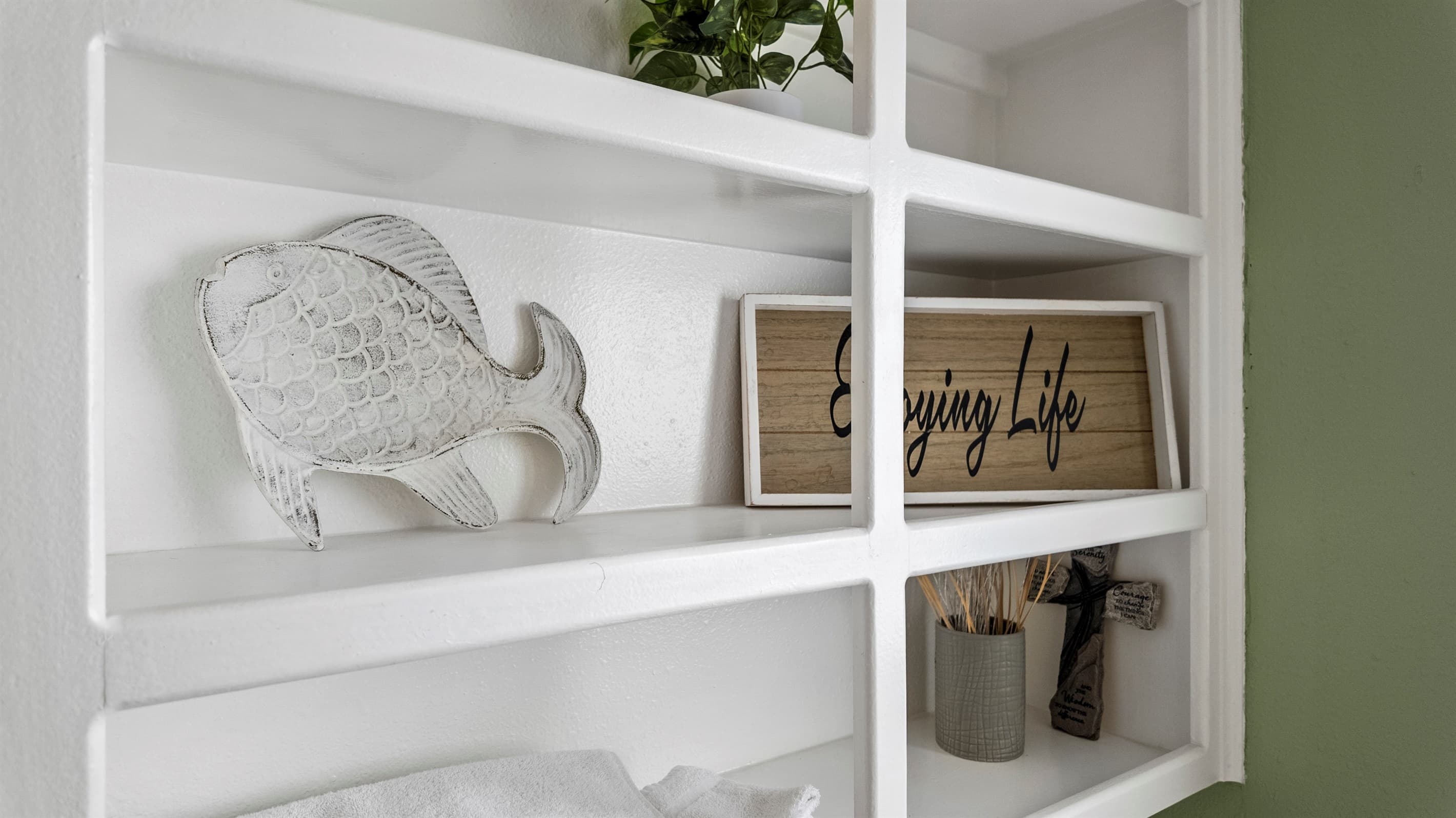 Coastal details in the master en-suite at Lakeview Landing — "Enjoying Life" sums up every stay at this Galveston waterfront retreat.