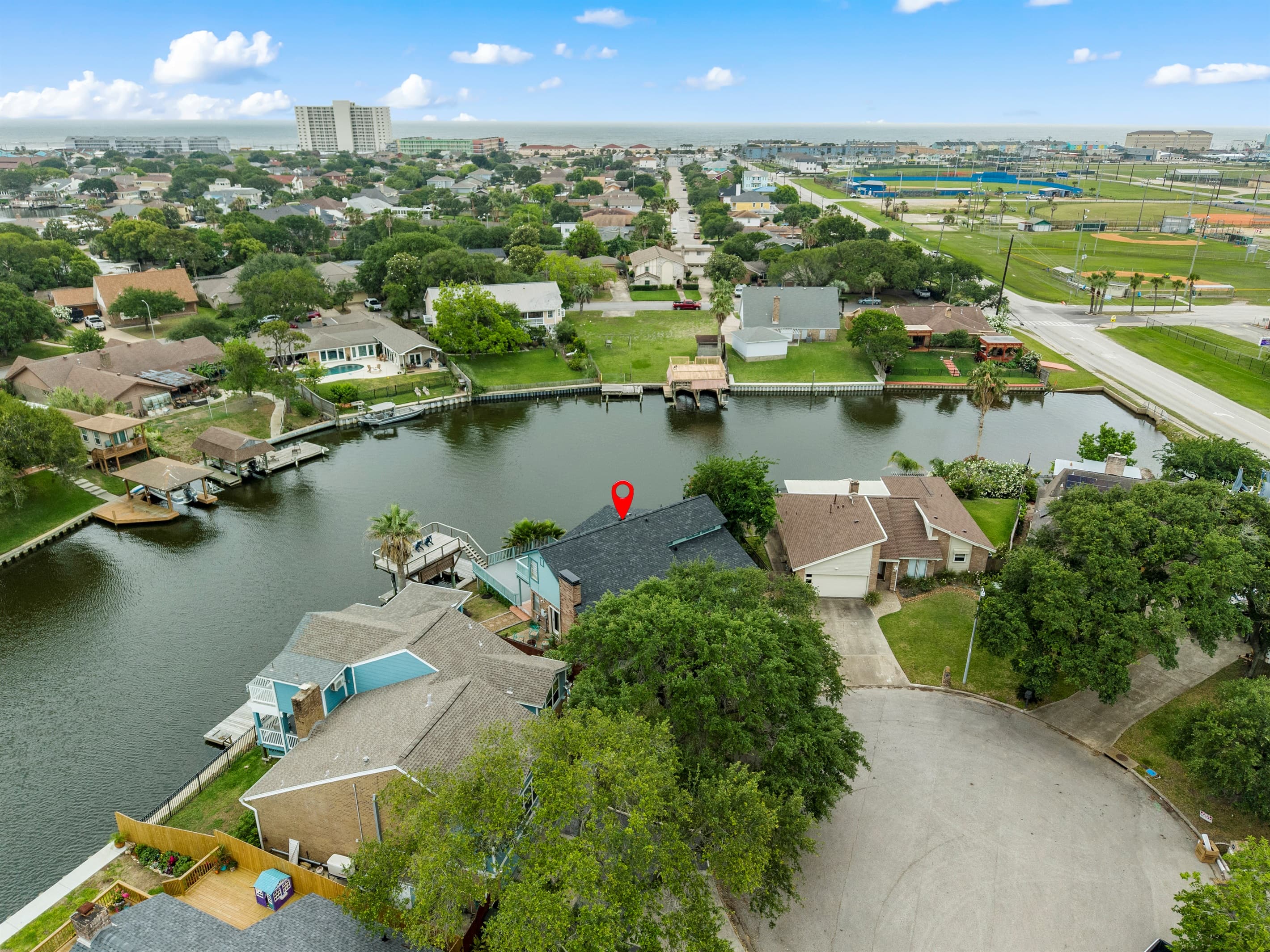 Aerial of Lakeview Landing — the teal exterior and private dock clearly visible on beautiful Madeline Lake, Galveston TX.