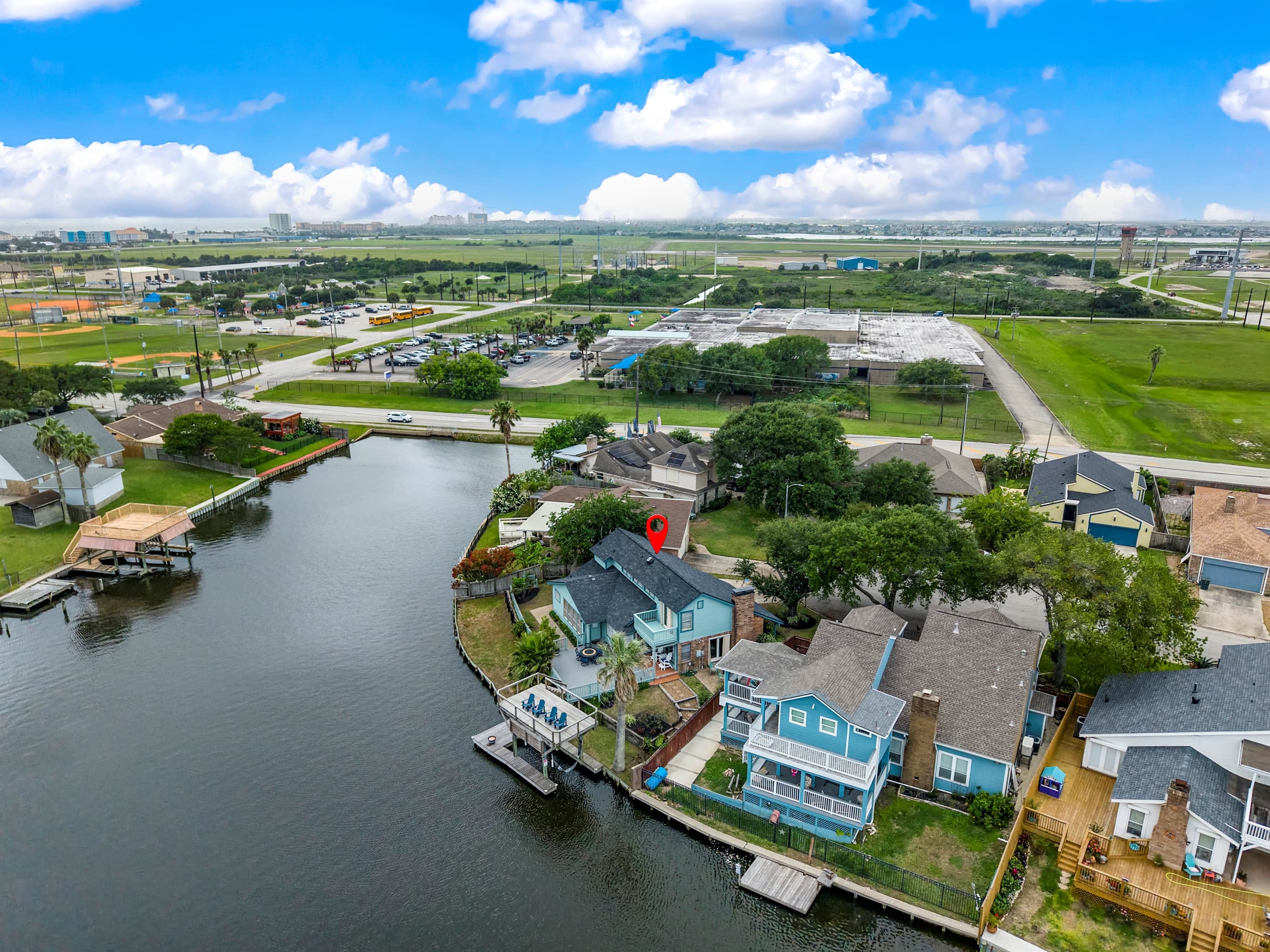 Aerial of Lakeview Landing — the teal waterfront home on Madeline Lake with private dock, at the heart of Galveston's waterway community.