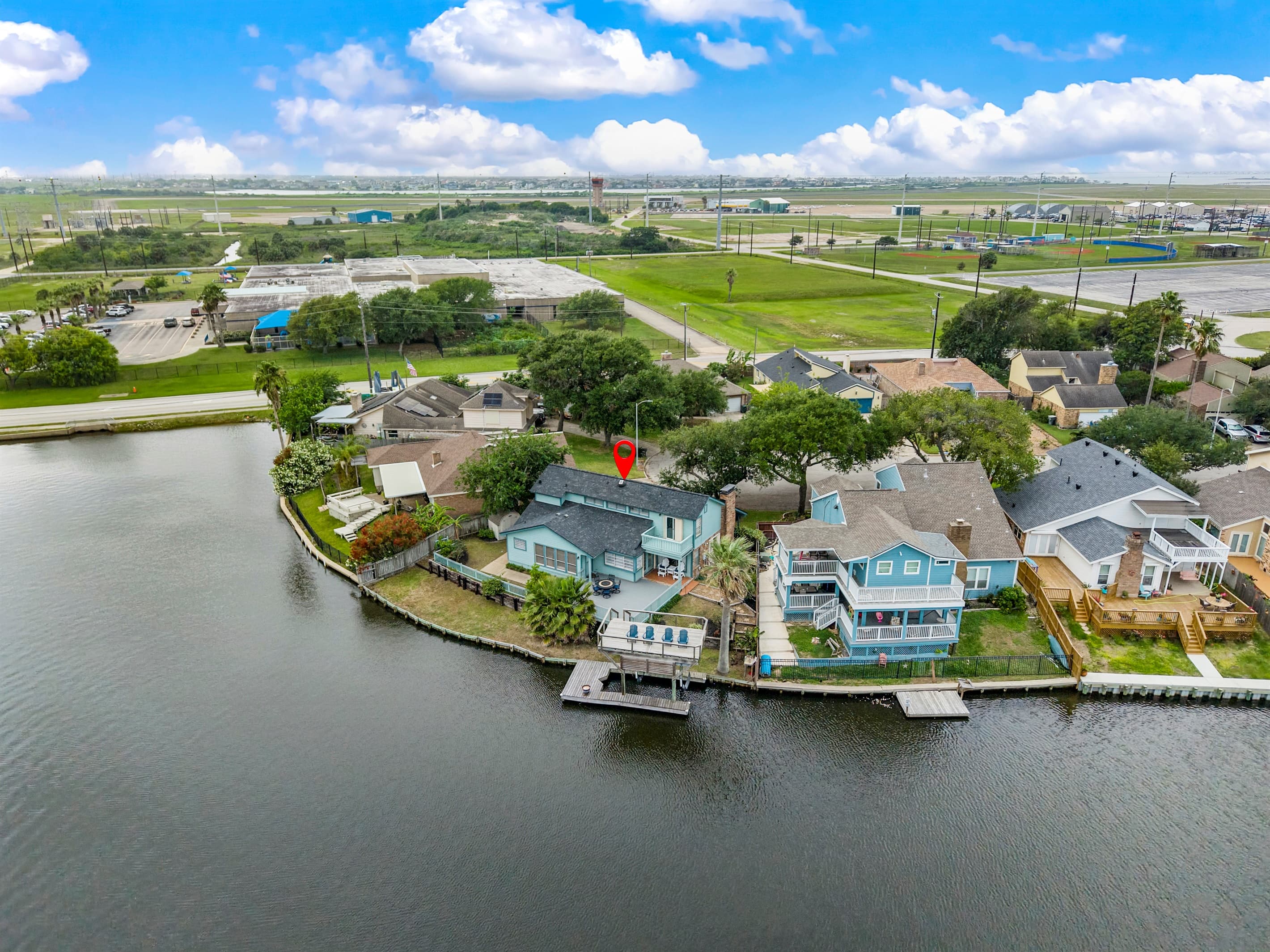 Lakeview Landing from above — Madeline Lake wraps around the property, offering waterfront views from multiple sides of this Galveston retreat.