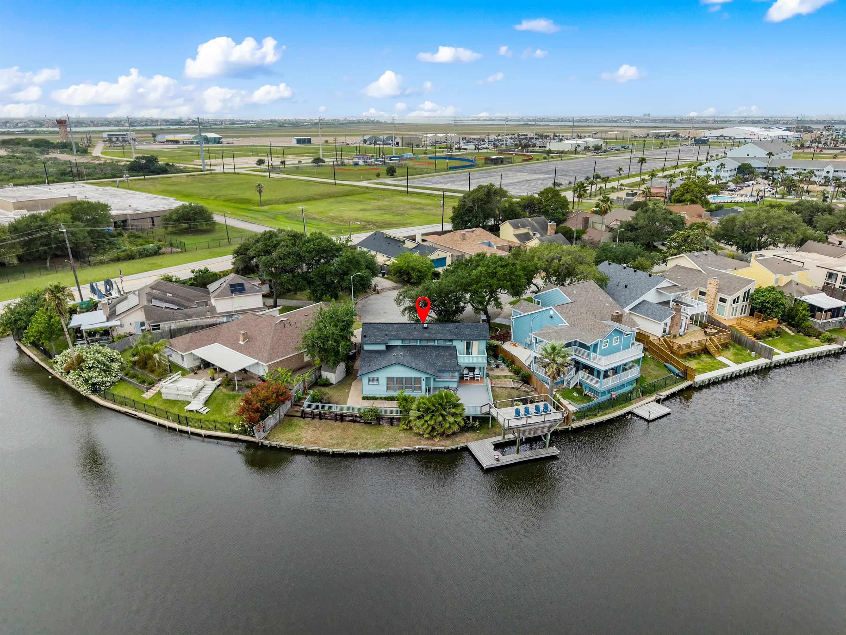 Aerial highlighting Lakeview Landing's private dock and boat lift on Madeline Lake — the red pin marks your Galveston waterfront home.