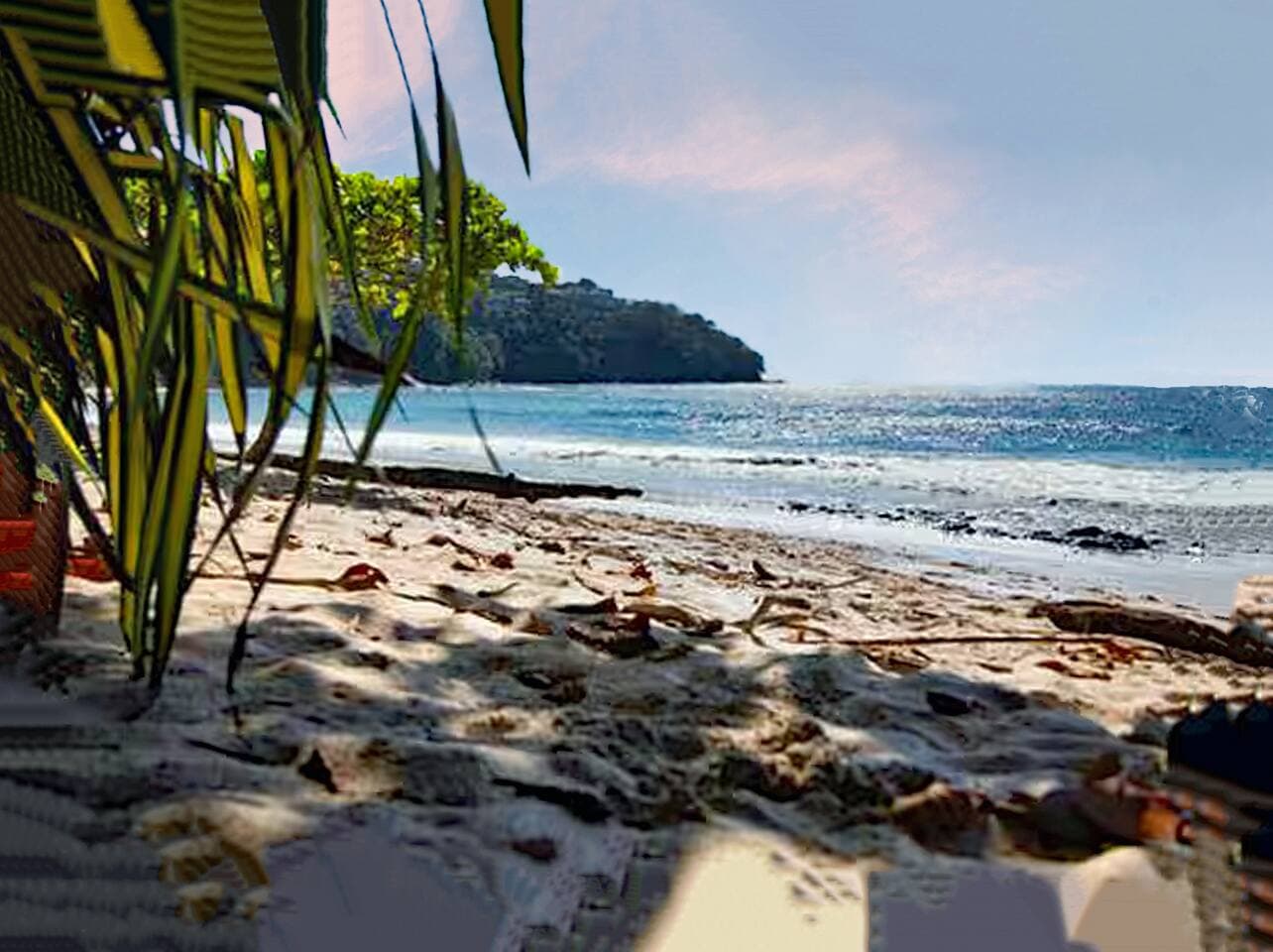 Breathtaking Playa Blanca, known for its white sand and calm waters — restrooms are conveniently located at the center of the beach.