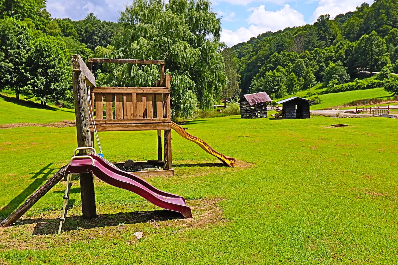 Community playground near fishing pond. 