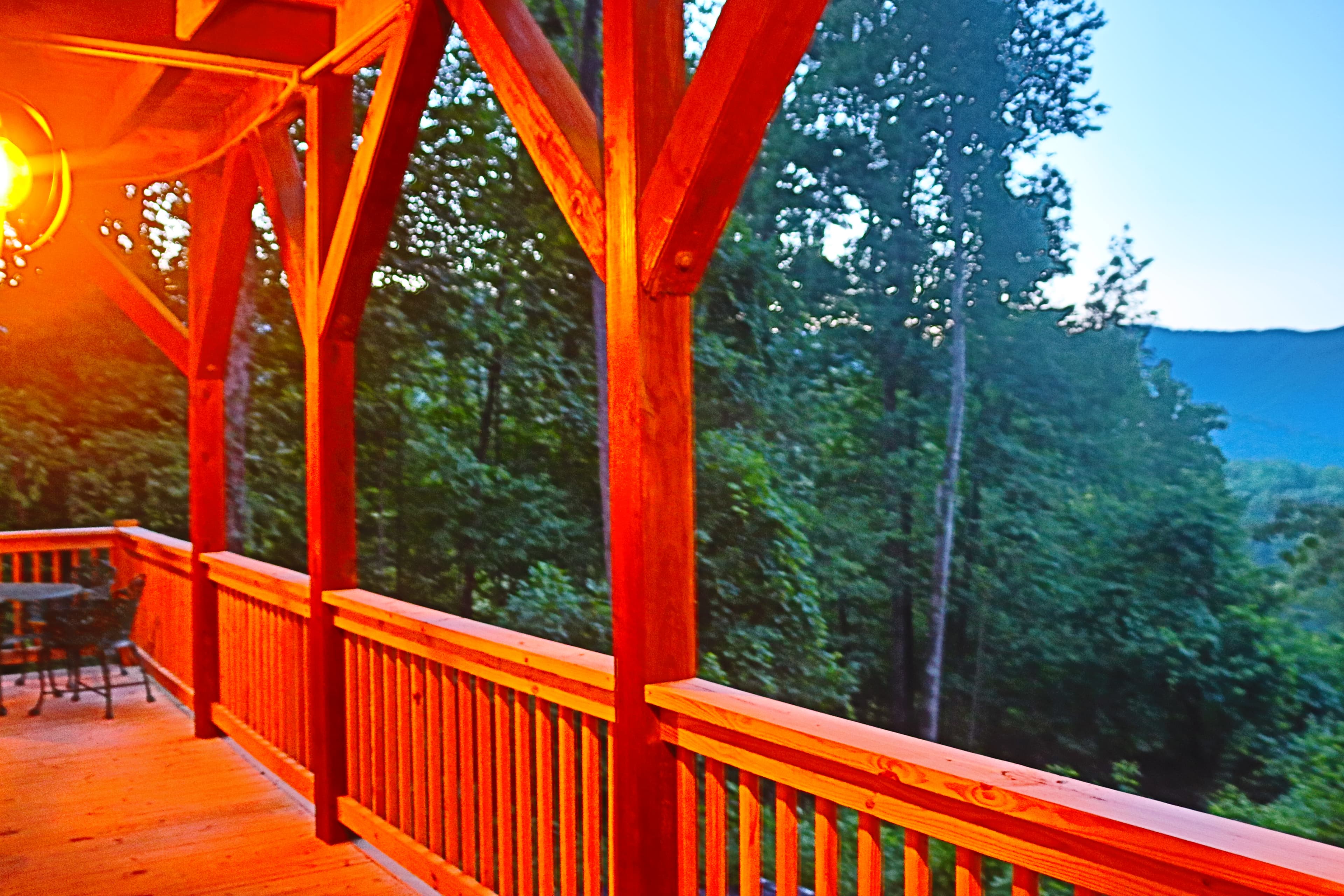 Dusk on the porch near hot tub with mountain views.