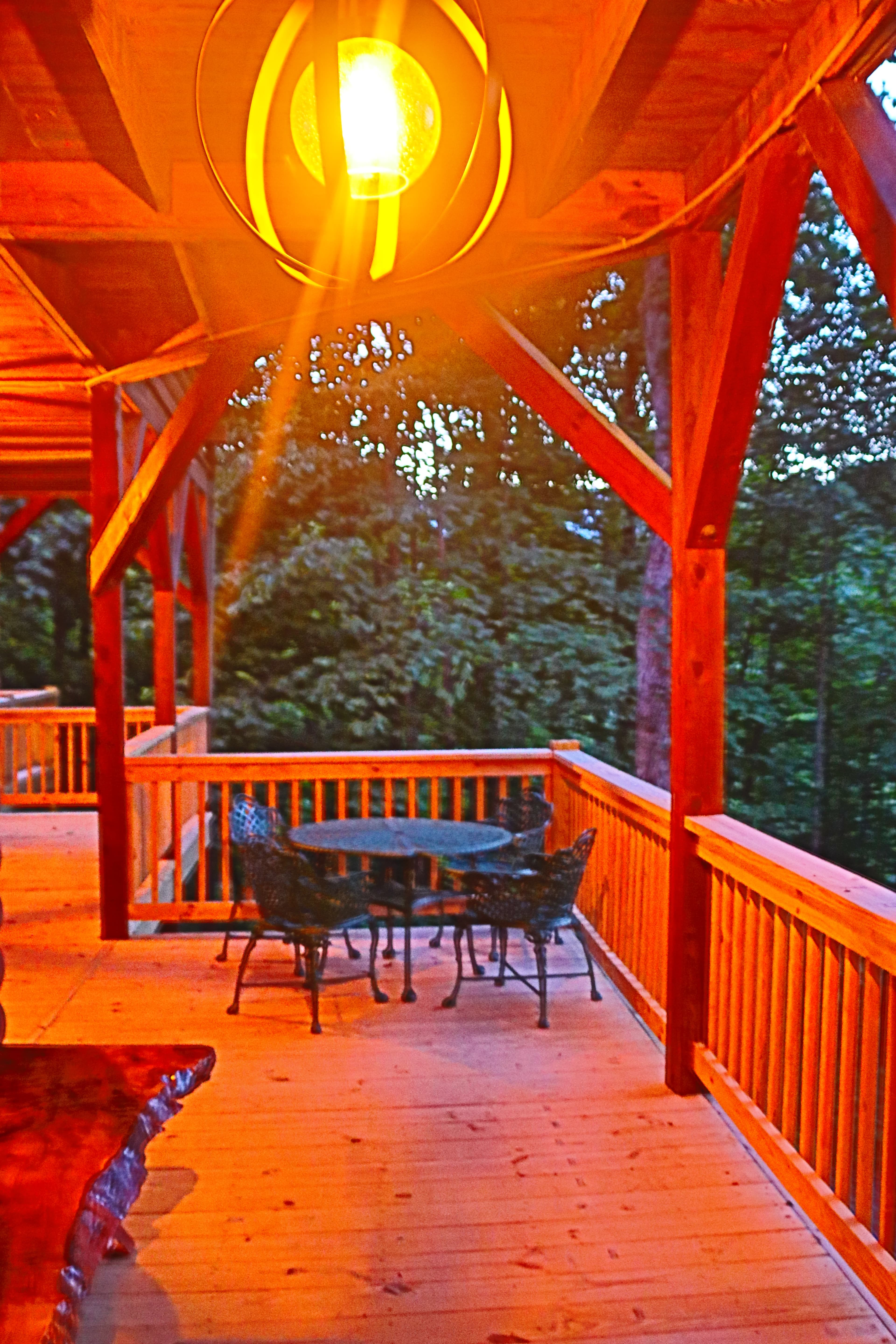 Dusk on the porch near hot tub with mountain views.