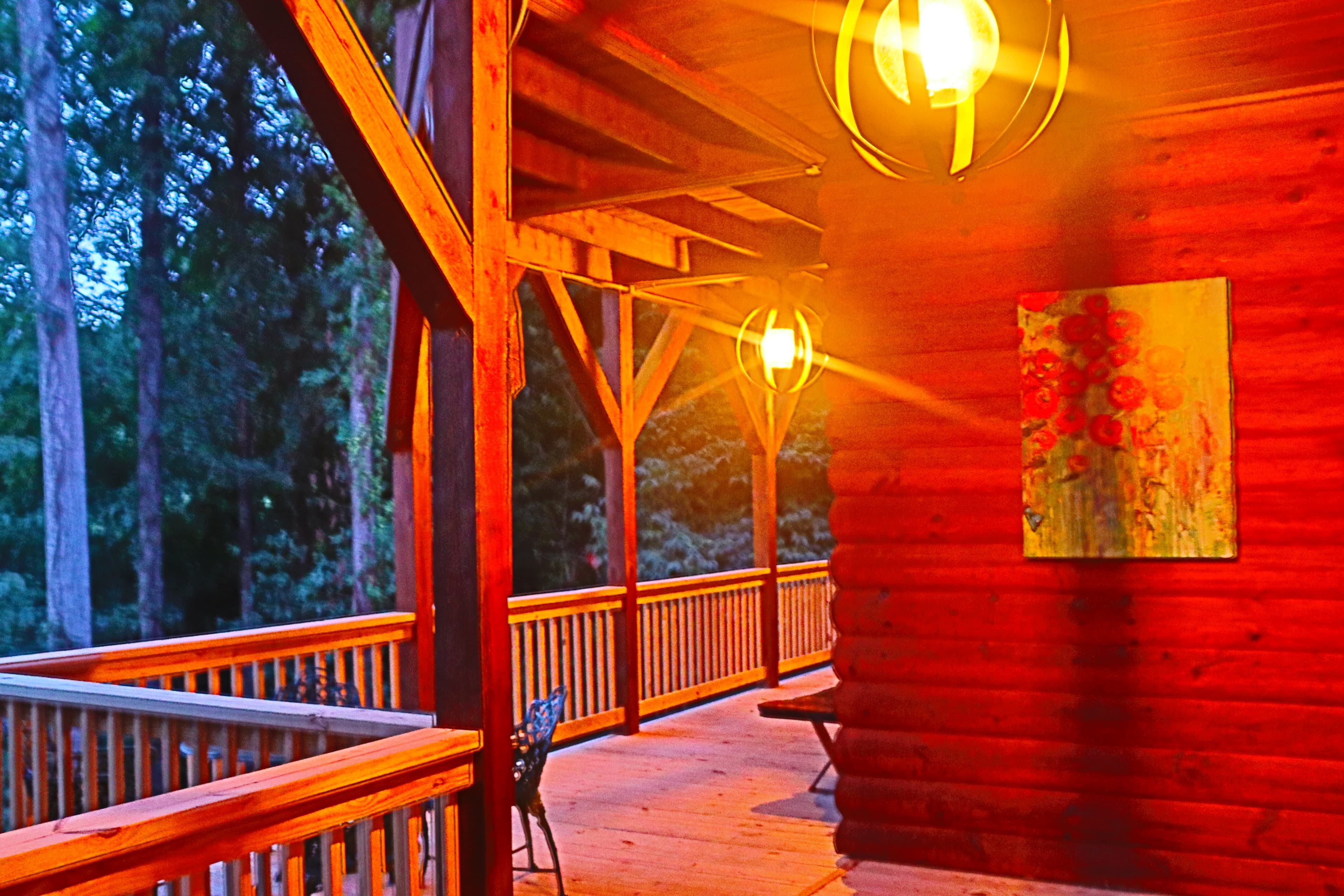 Dusk on the porch near hot tub with mountain views and outside art.