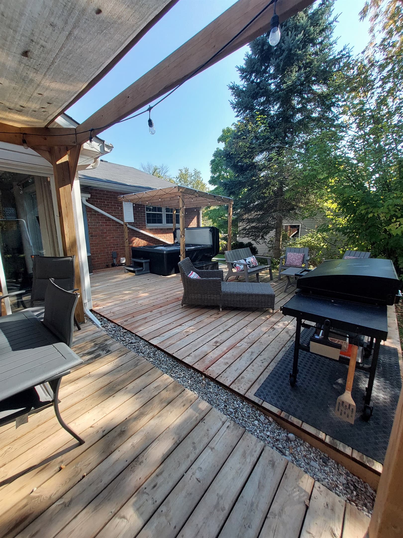 Spacious deck for every mood—grill, dine, lounge, or soak in the rain-proof hot tub.