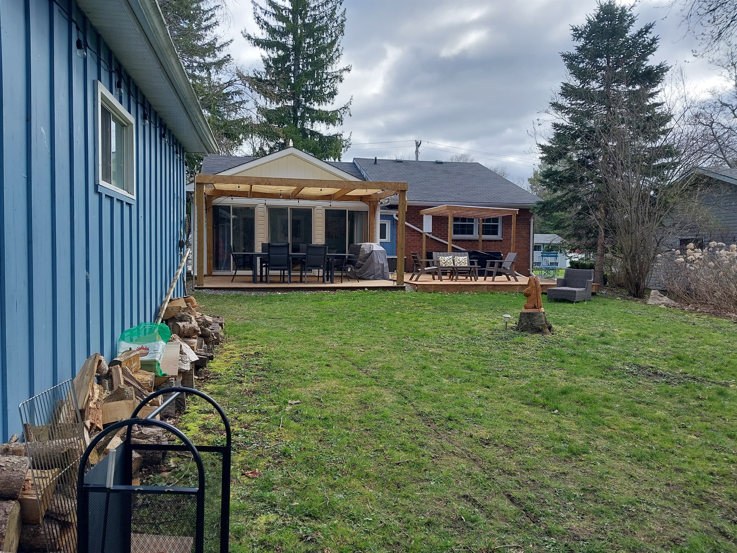 Your home for outdoor moments: roomy deck space and firewood ready for use.