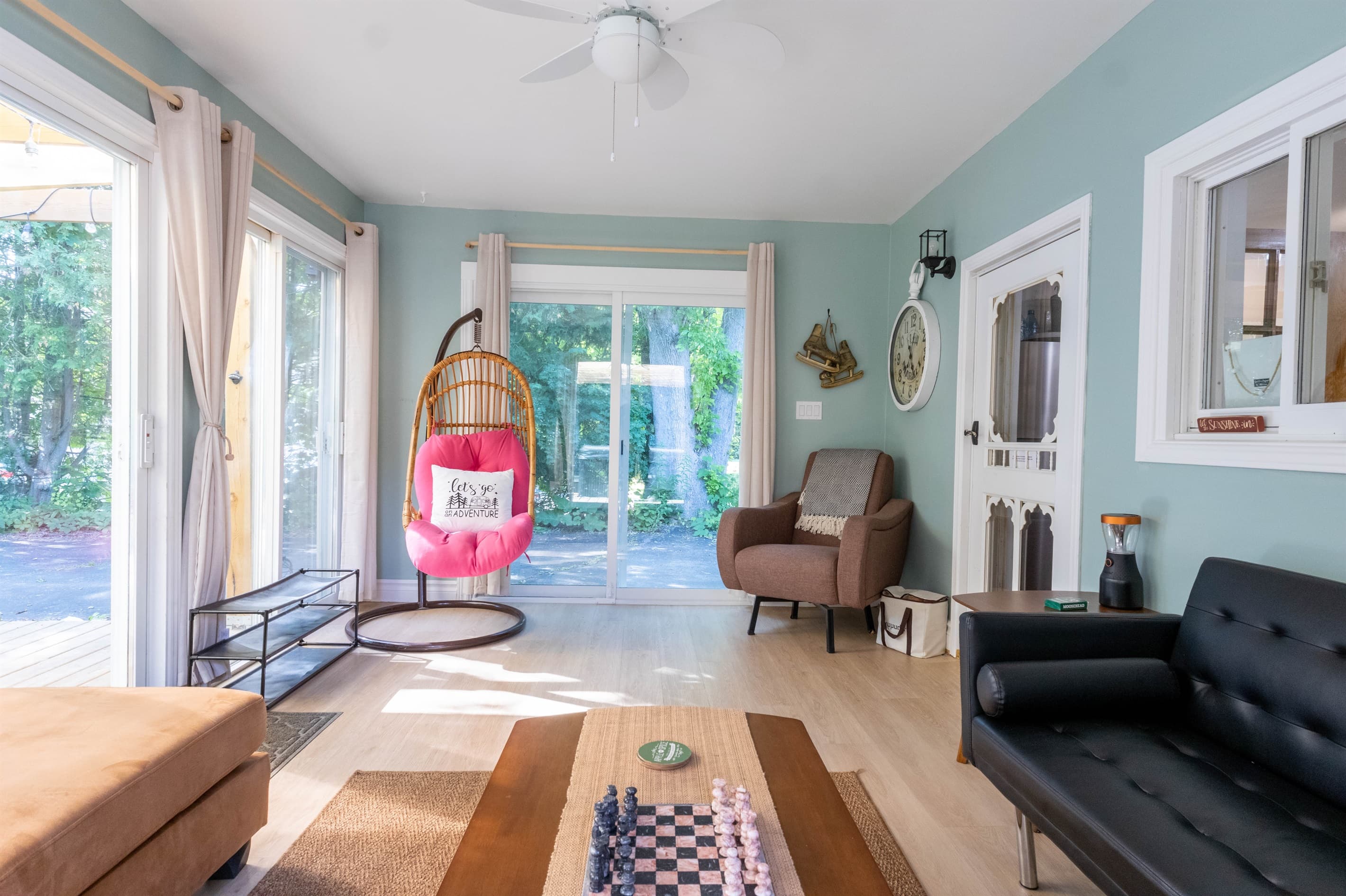 Relax year-round in our bright 3-season sunroom, complete with a cozy electric fireplace and a comfy egg chair for quiet moments.