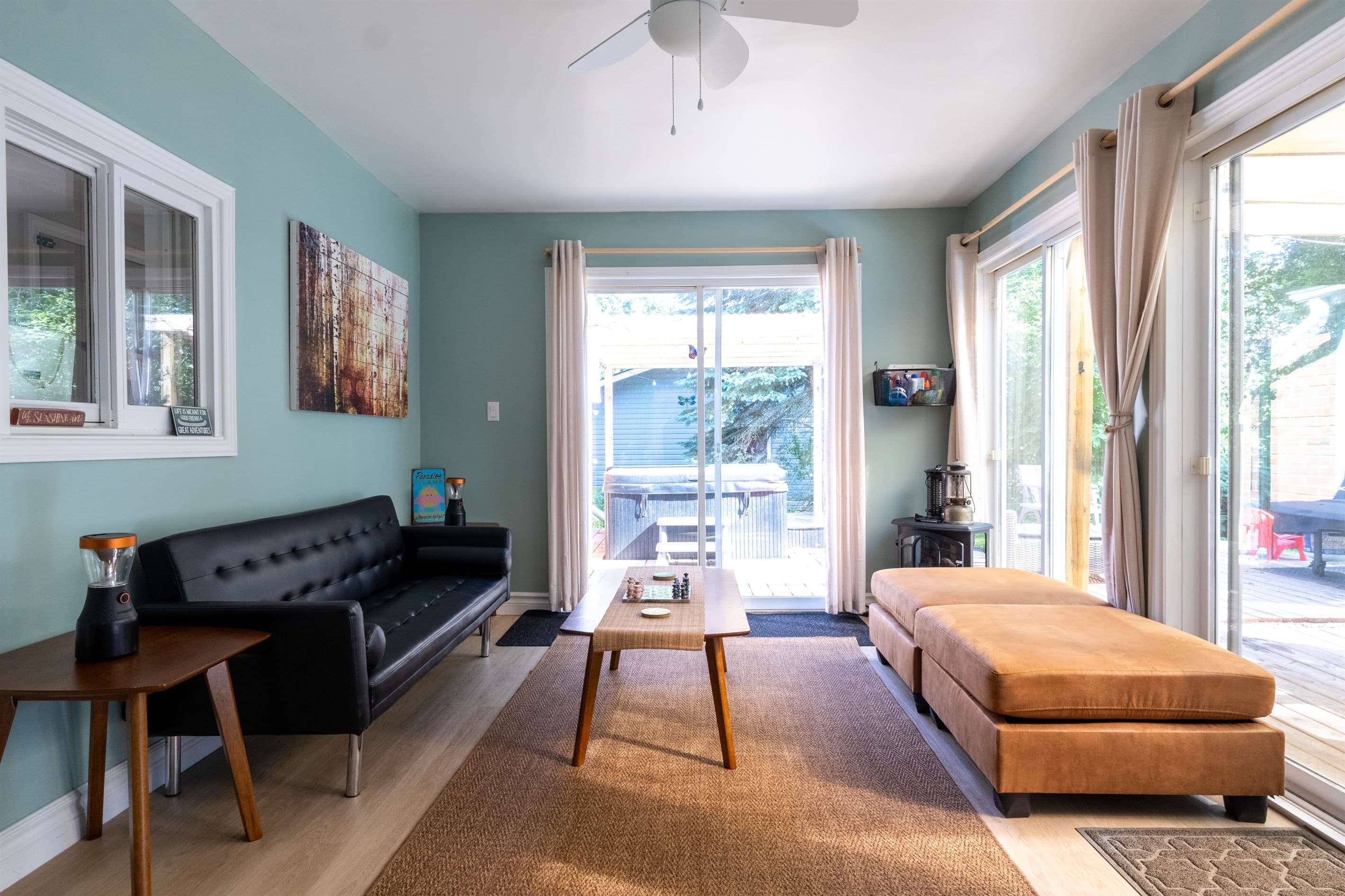 Relax year-round in our bright 3-season sunroom, complete with a cozy electric fireplace and a comfy egg chair for quiet moments.