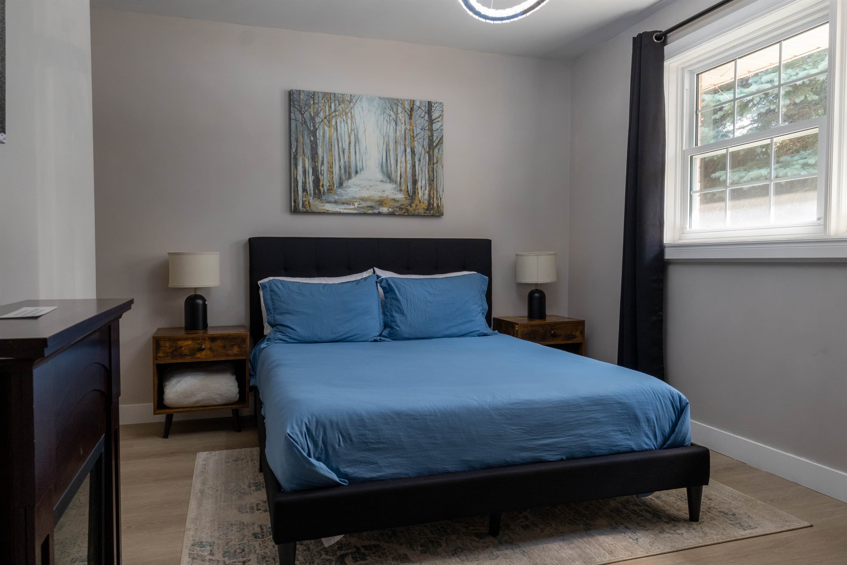 Bedroom 2: your quiet retreat with TV, dresser, closet, chair, USB lamps, electric fireplace and 2 plush robes for cozy nights in or a trip to the hot tub.