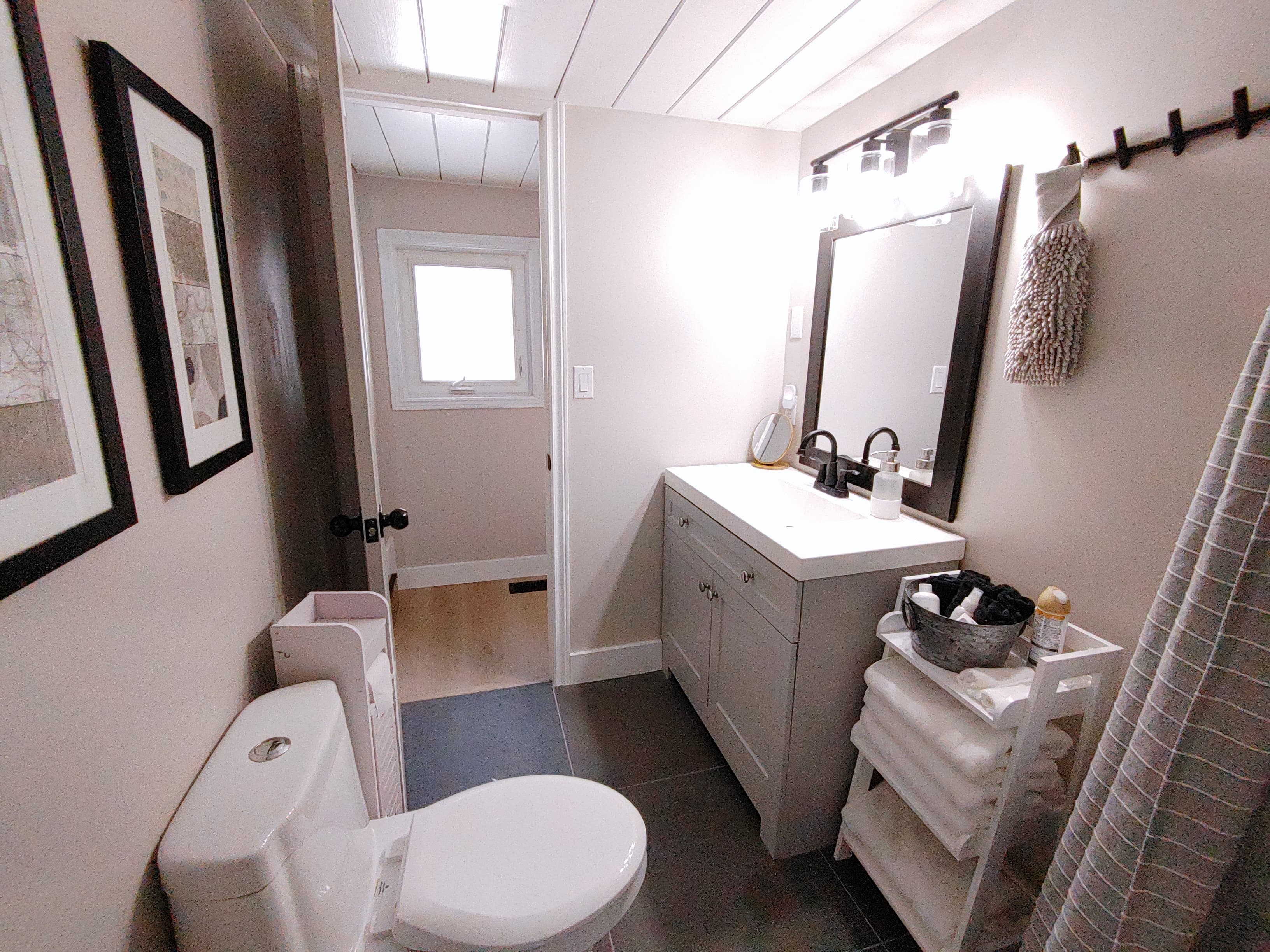 Family-friendly 4 piece bathroom with rain head shower, shampoo, bath toys, baby potty, and extra add ones to delight both the young and young-at-heart.