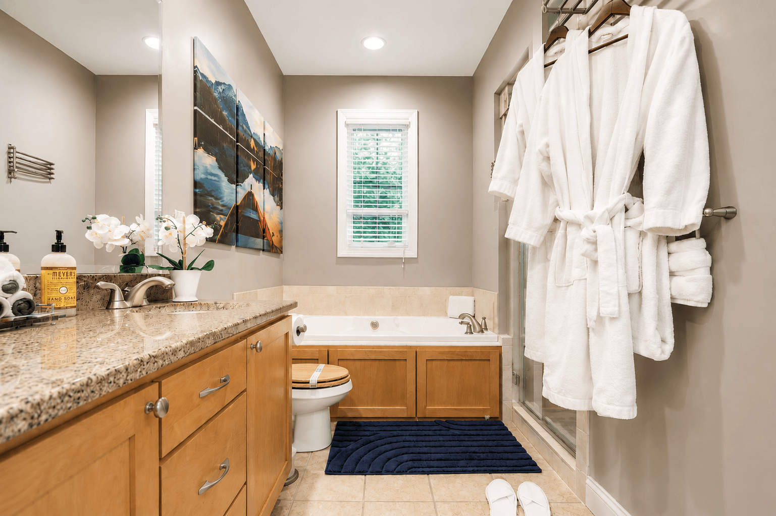 Spacious en-suite master bathroom with double sinks, a steam room, and a relaxing jacuzzi tub - your perfect retreat.