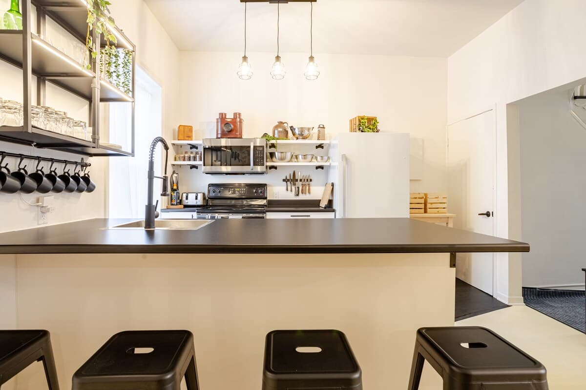Fully equipped kitchen with modern appliances, spices, quality knives, cookware, and dishwasher. Ideal for cooking, coffee, or casual dining in a sleek, organized space that opens to the dining area—perfect for foodies and families alike.