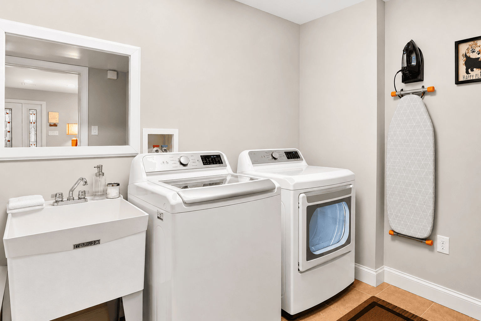 Full-size washer & dryer equipped with Iron and Iron Board, Clothing Steamer, and Laundry Sink for your convenience.
