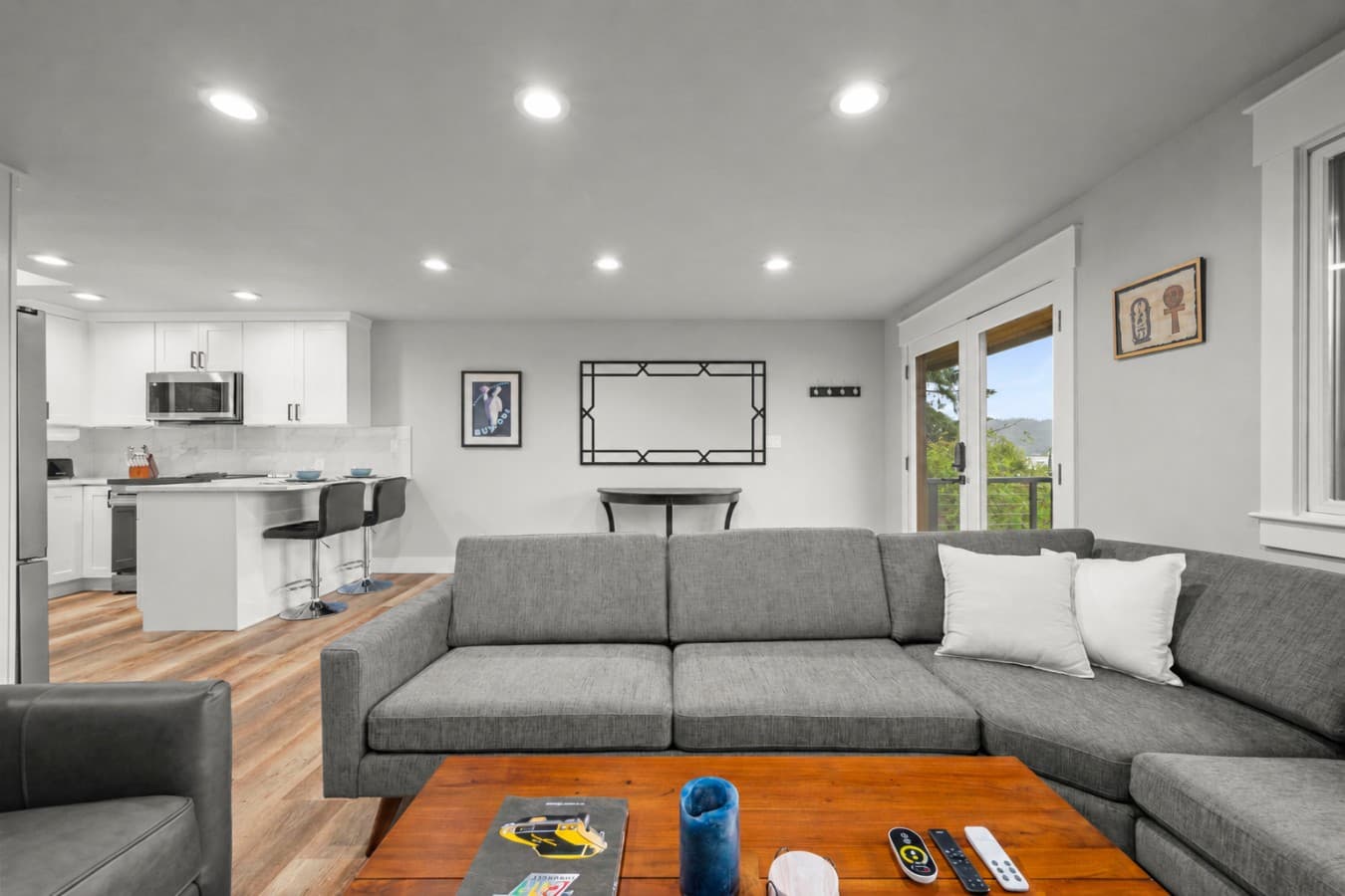 A spacious sectional sofa and comfortable armchair provide plenty of seating for family and friends..png