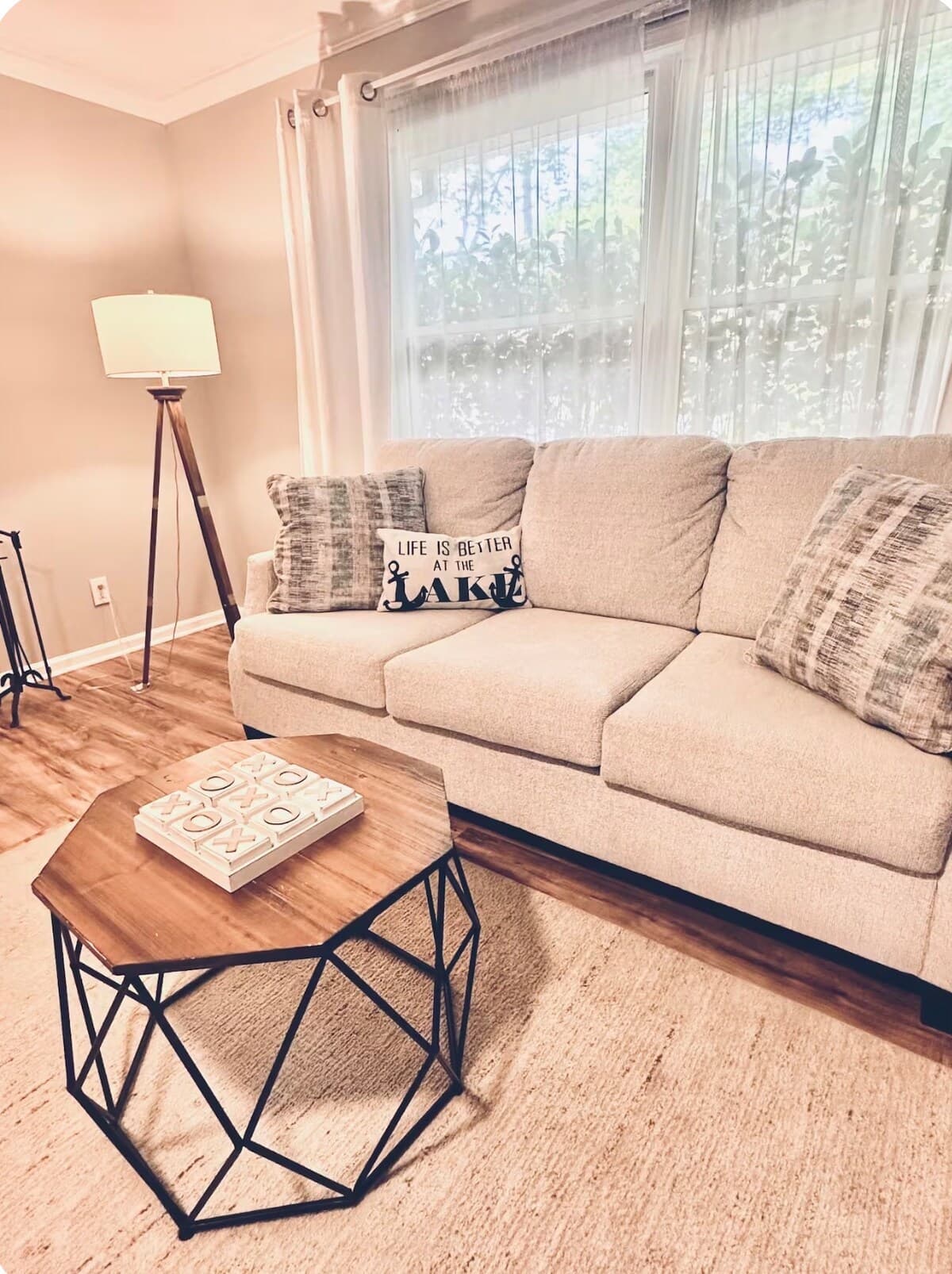 Room for the whole family to gather — multiple sofas, soft rug, warm light.
spacious living room, multiple sofas, brick fireplace, crown moulding, large group rental, jute rug, family gatherings, reunion-ready.