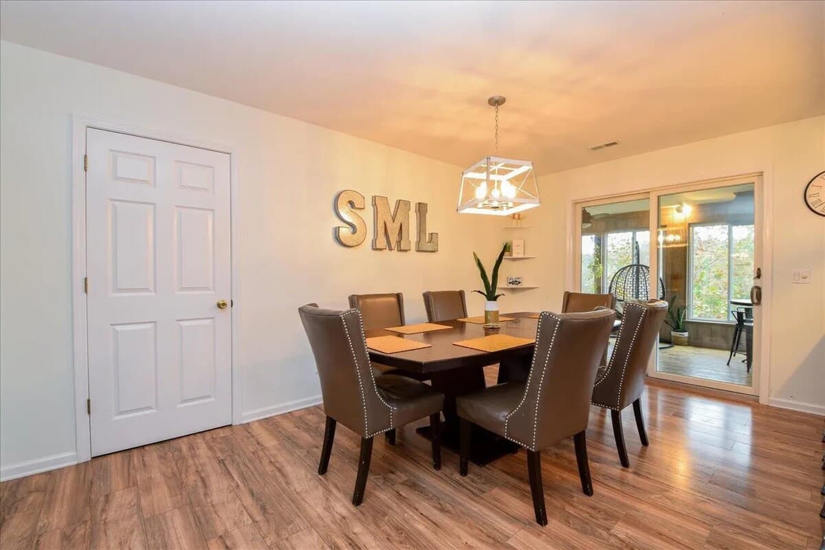 Smith Mountain Lake family dinners, done right. Dining for 6-8, leather dining chairs, nailhead trim, lantern chandelier, Smith Mountain Lake, SML, sunroom access, formal & Casual dining, golden-hour dinners.