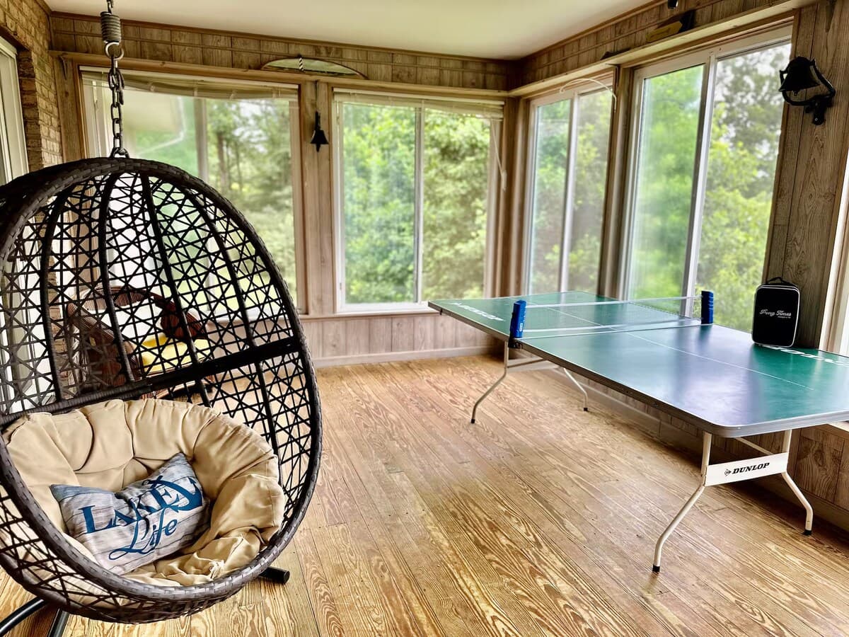 Ping pong table on-site — everyone plays at SML.

table tennis, game room, hanging egg chair, wraparound windows, Smith Mountain Lake, family-friendly amenities, all-season play.