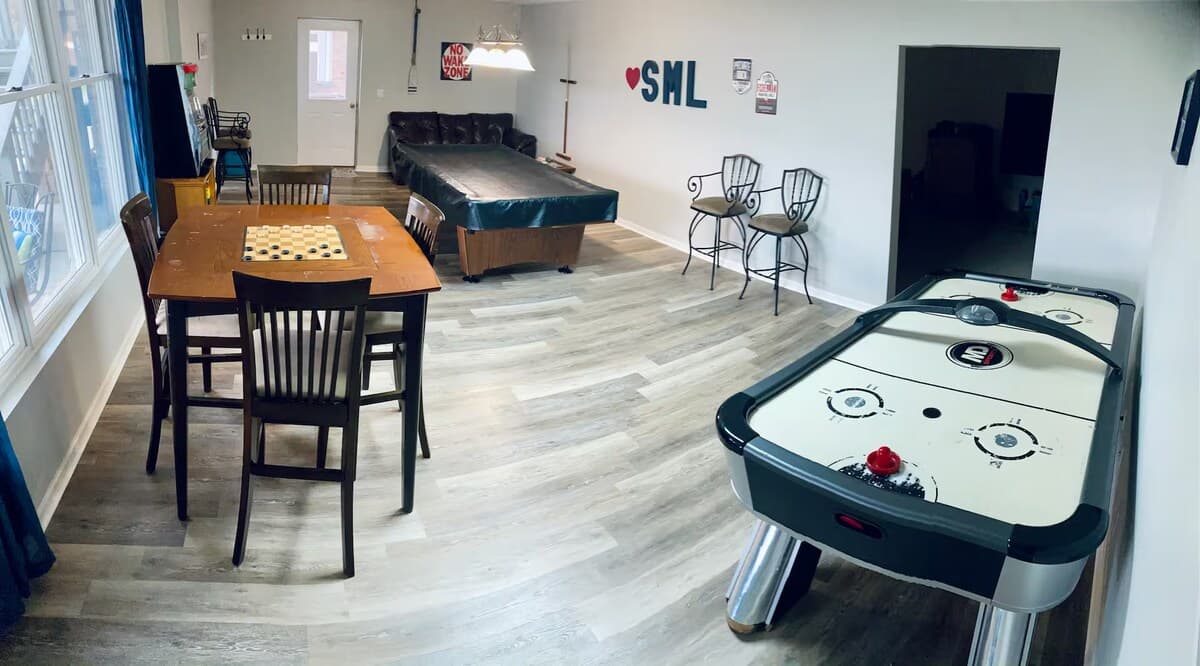 Game room for days — pool, air hockey, checkers, connecting to kiddos play area and a ♥SML gathering spot.

pool table, air hockey, checkers, game tables, Smith Mountain Lake, SML, lower-level game room/kids play room, family reunion, group rental.
