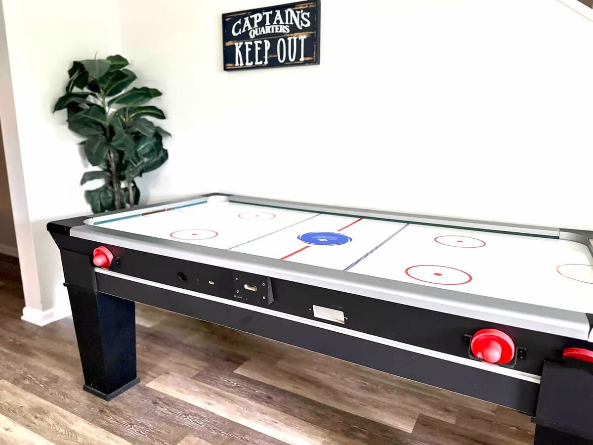 Full-size air hockey — 'Captain's Quarters, Keep Out' energy.

air hockey table, game room, rainy day activity, tournament-ready, family-friendly, lower-level, lake house games.
