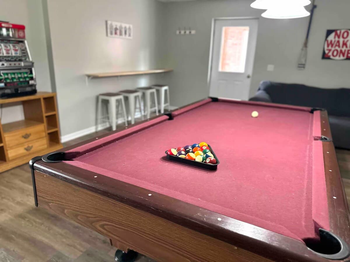 Pool table & slot machine — game-room energy just steps from the lake.

pool table, slot machine, bar seating, billiards, game room, adult fun, bachelor party, bachelorette, lake house rental.
