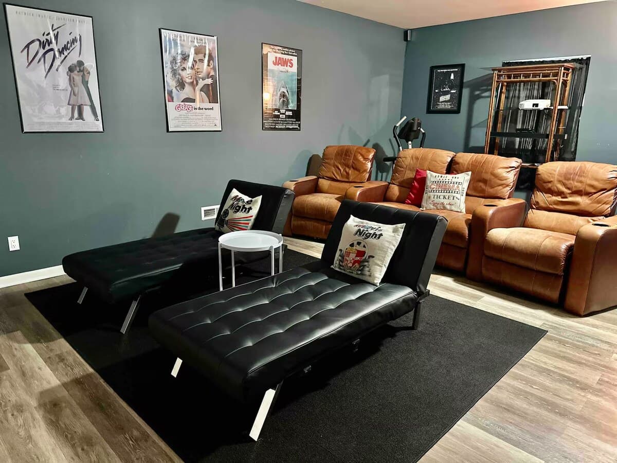  Stadium theater inspired seating — leather recliners, movie posters, and popcorn-ready lounges.

Theater recliners and lounges, stadium seating, movie room, Jaws, Grease, Dirty Dancing, movie posters, family entertainment, private screening.
