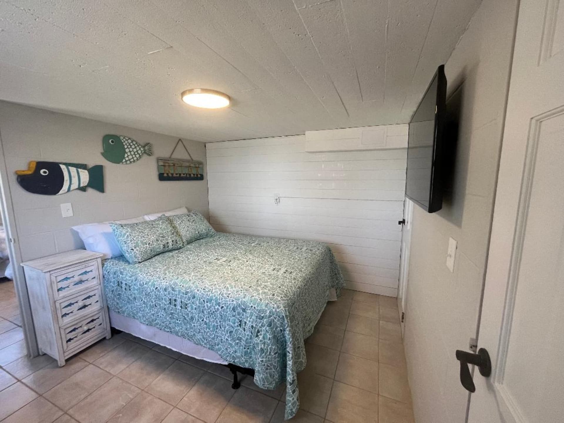 Downstairs bedroom with a queen bed