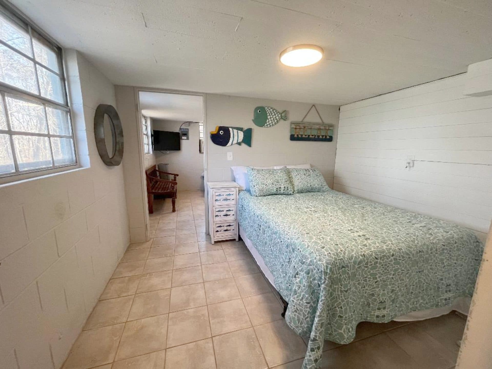Downstairs bedroom with a queen bed