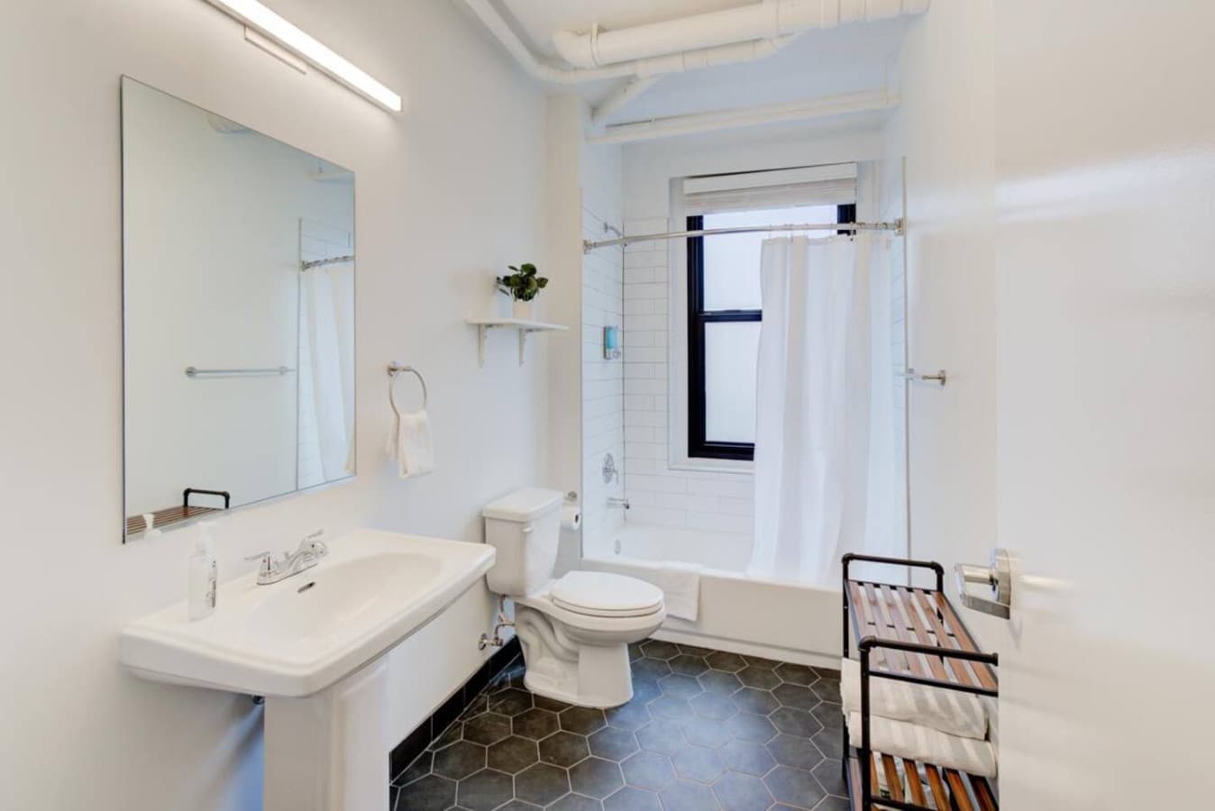 Full-size bathroom with tub. Clean off your day’s stress and anxiety. Enjoy a relaxing warm bath. You will have all the essentials you’ll need for your stay from soap, shampoo, and plenty of fresh, clean white towels.