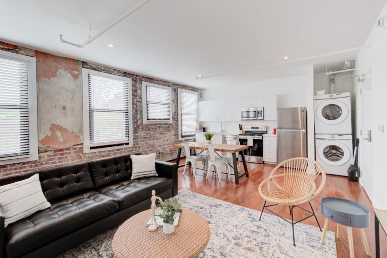 Spacious open-concept living with a fully equipped kitchen, dining area, and convenient laundry, all seamlessly connected for a comfortable, modern experience.