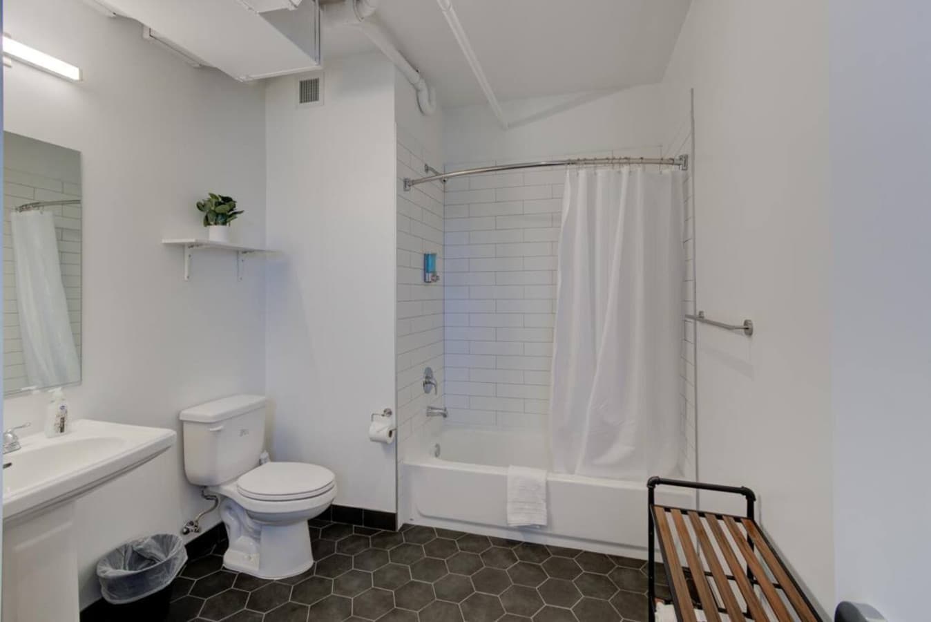 Modern full bathroom with a tub/shower combo for ultimate relaxation after a day of exploring.