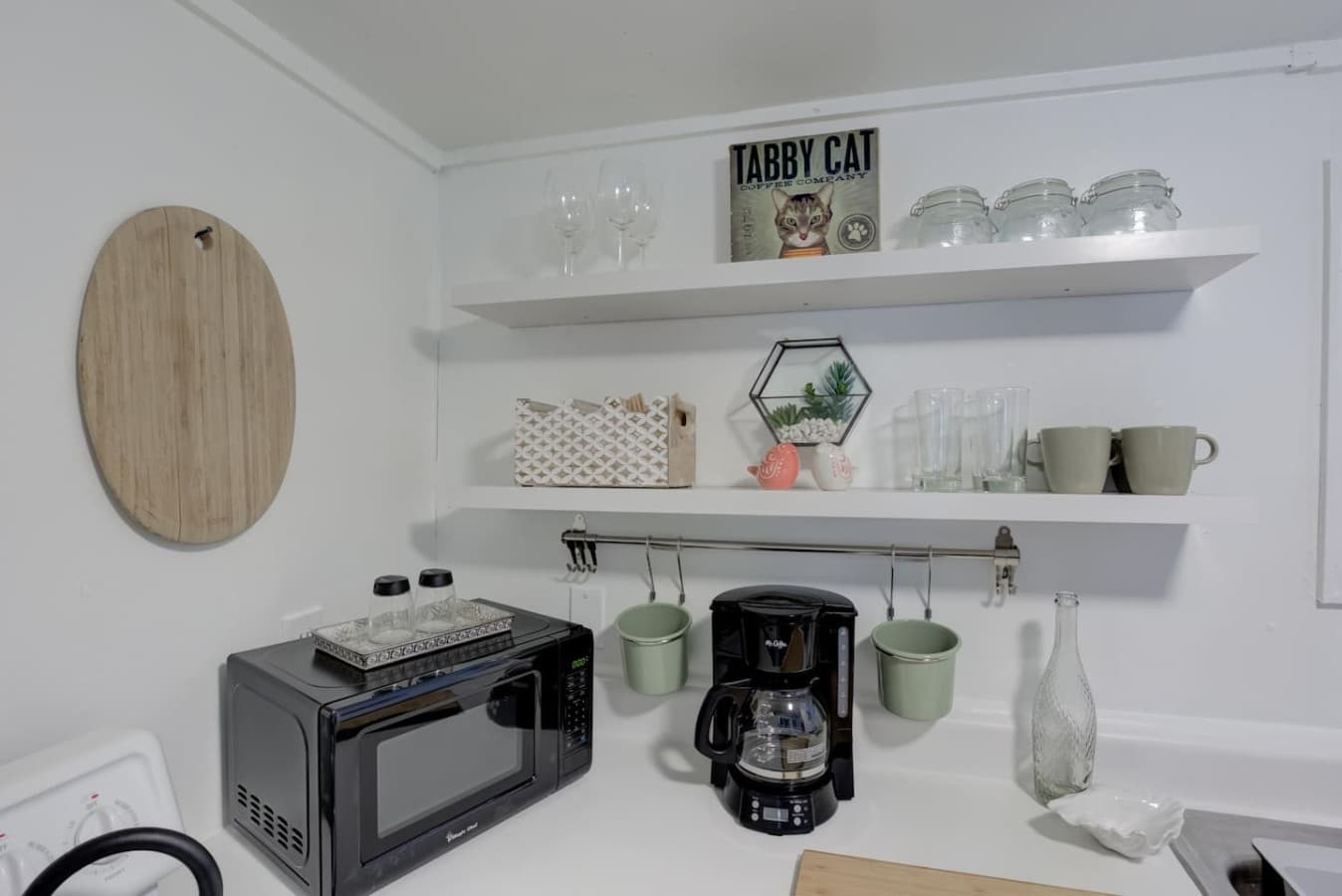 One of three kitchens featuring basic essentials, appliances, and coffee.