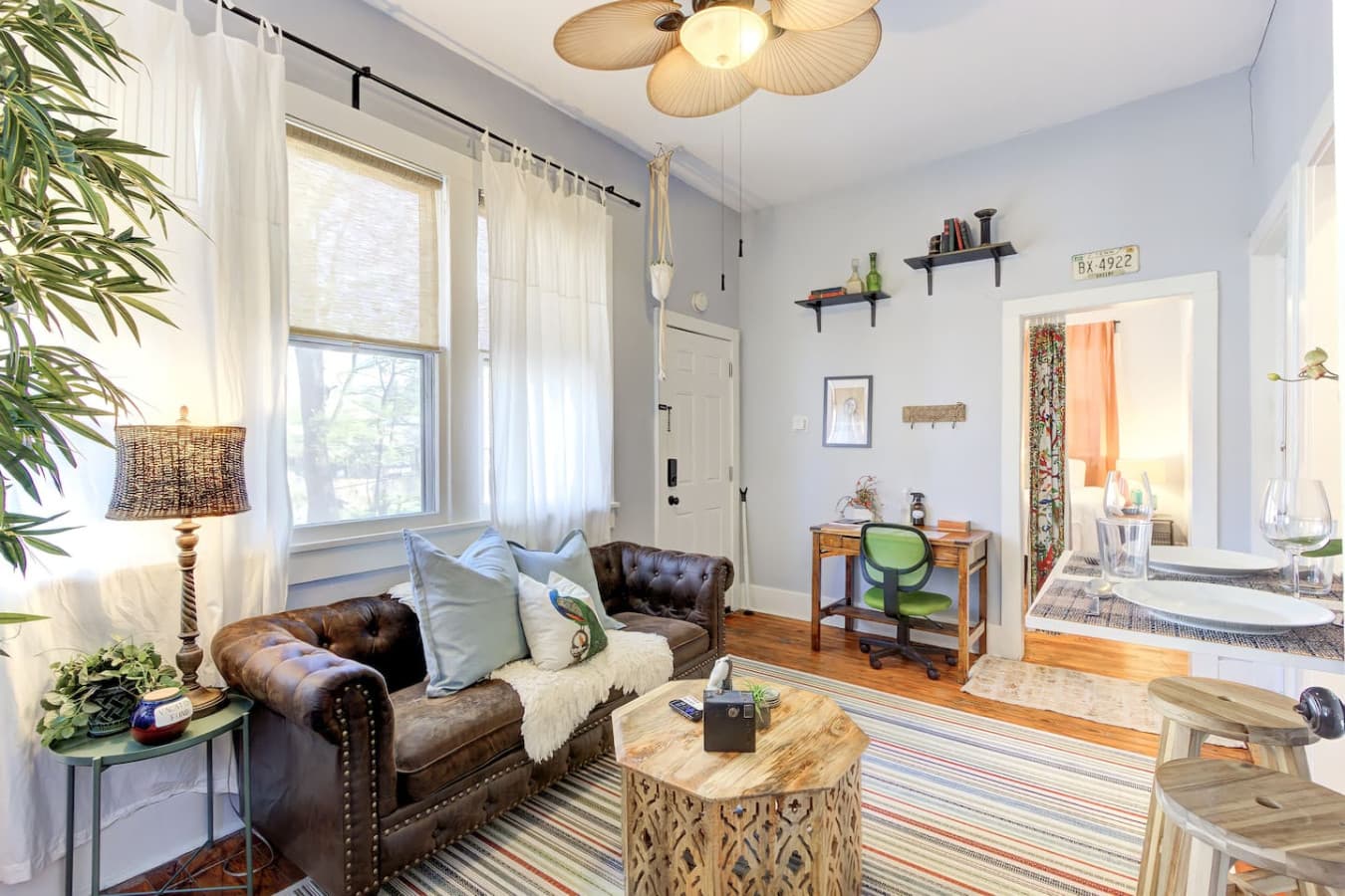 The cozy leather sofa invites you to drop your bags and sink in, while the striped rug adds a cheerful touch underfoot.