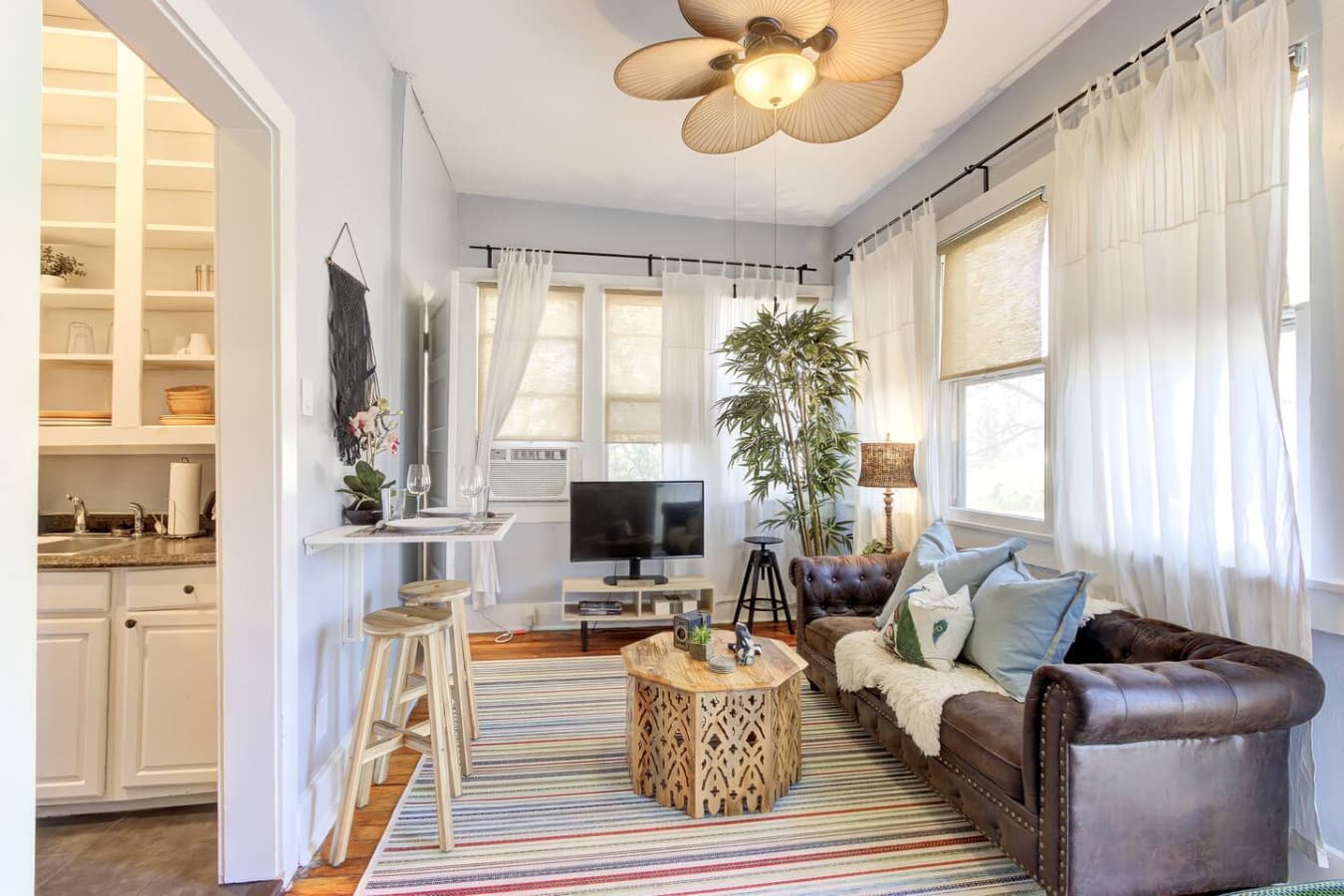 Step into the bright, welcoming living room. The space is perfect for relaxing or enjoying a drink at the bar-style table.