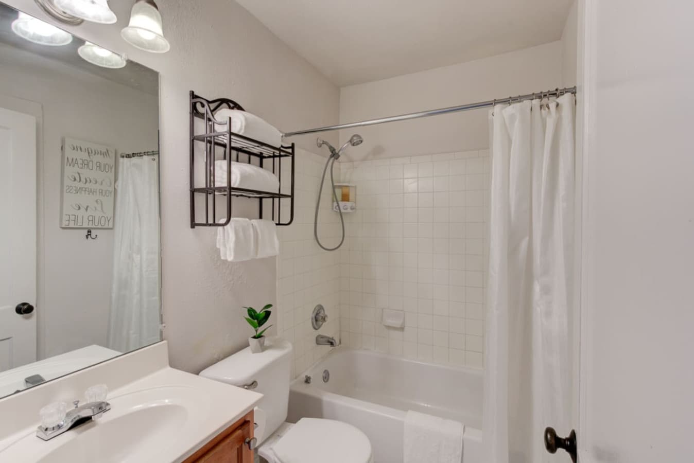 Freshen up in the full bathroom featuring a versatile shower–tub setup.