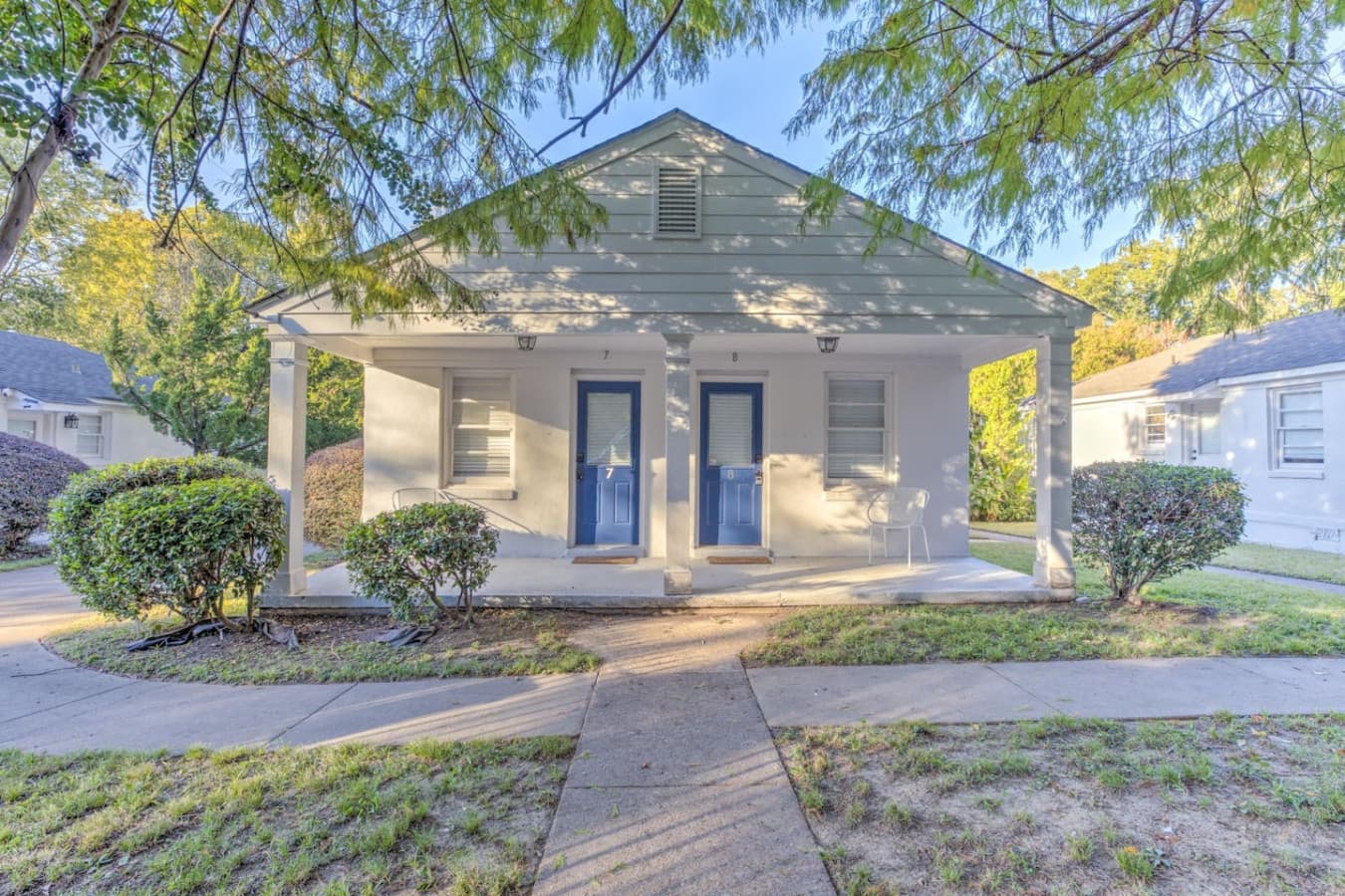 Blue door, cottage charm, and all the welcoming vibes you need for your stay.