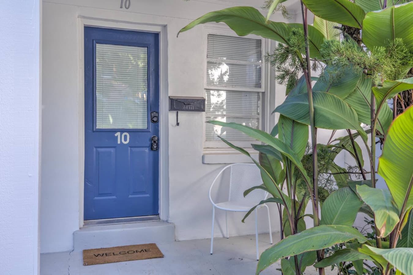 A pop of blue at the door and a comfy spot to sit on the porch.