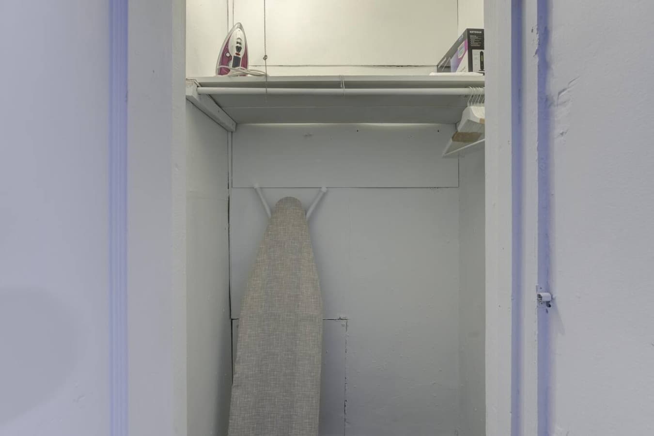 Your closet with the iron, ironing table and hangers all provided for your use.