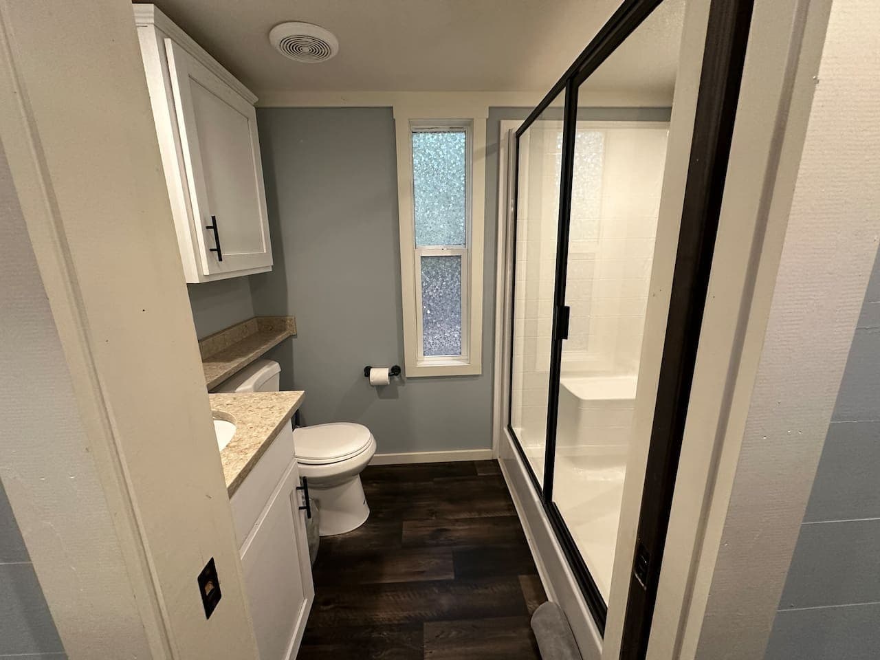 Clean, modern full bath with a sleek walk-in shower.