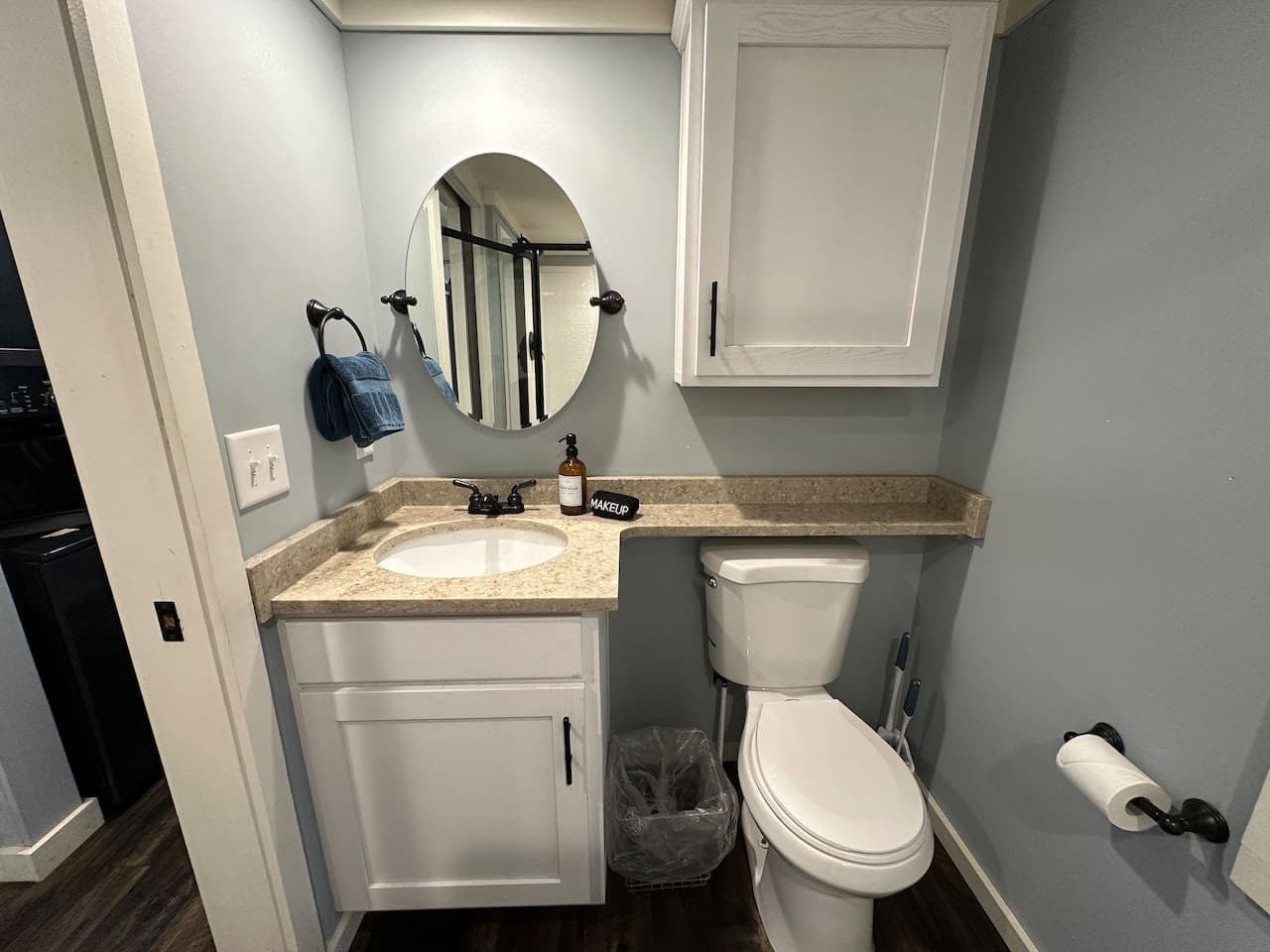 Warm, simple vanity and toilet for everyday comfort.