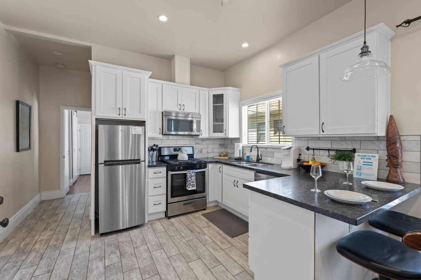 A full-sized kitchen equipped with all the essentials to prepare a delicious home-cooked meal, including pots, pans, olive oil, salt, pepper, and more.