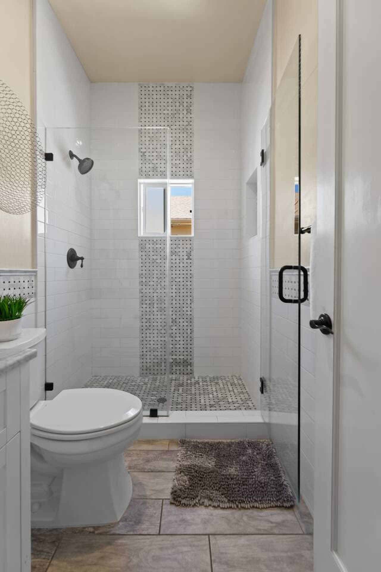 Fully remodeled bathroom with marble accents and shampoos and soaps and fresh white towels ready for you.