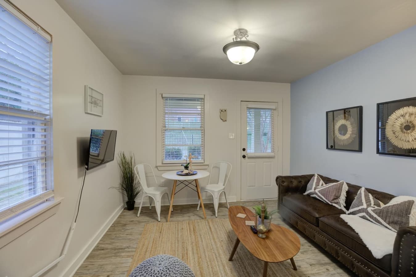 Relax, dine, and stream—Chesterfield sofa, dining for two, and smart TV await.