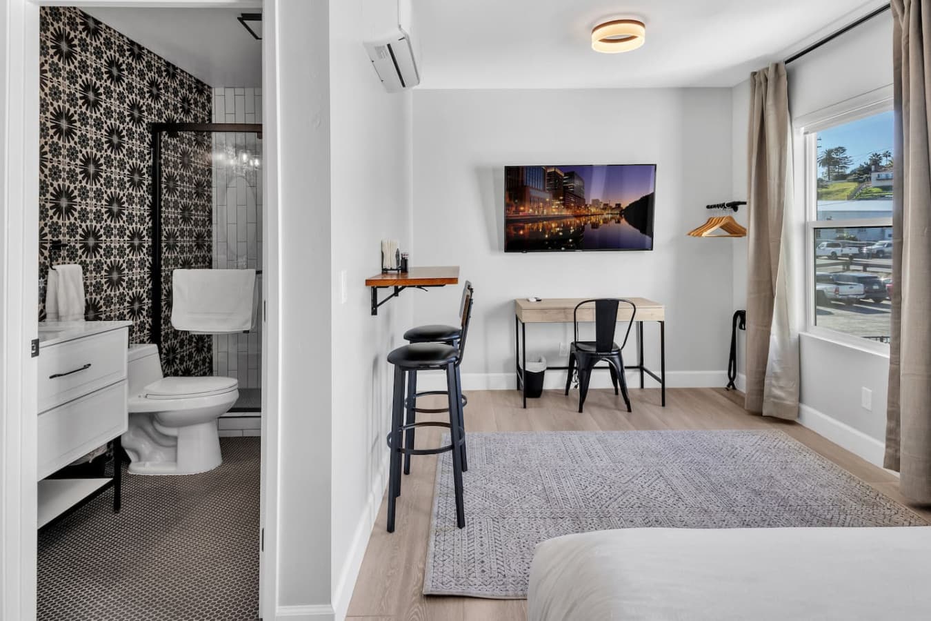 View of the bathroom, dining area, workspace area, and TV
