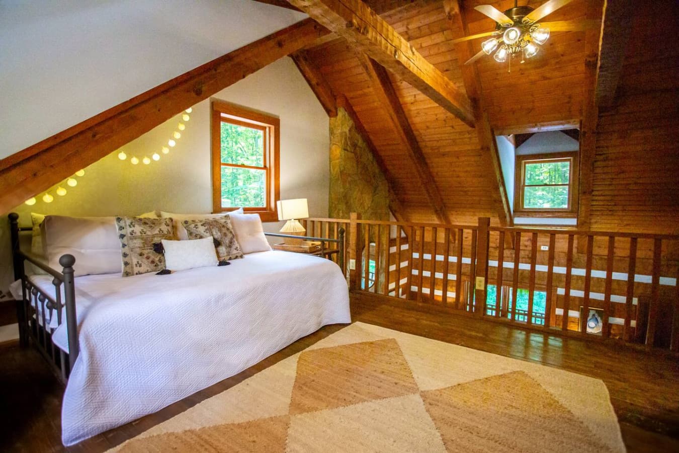The loft offers flexible sleeping space with a queen bed and a second queen that slides out when needed.