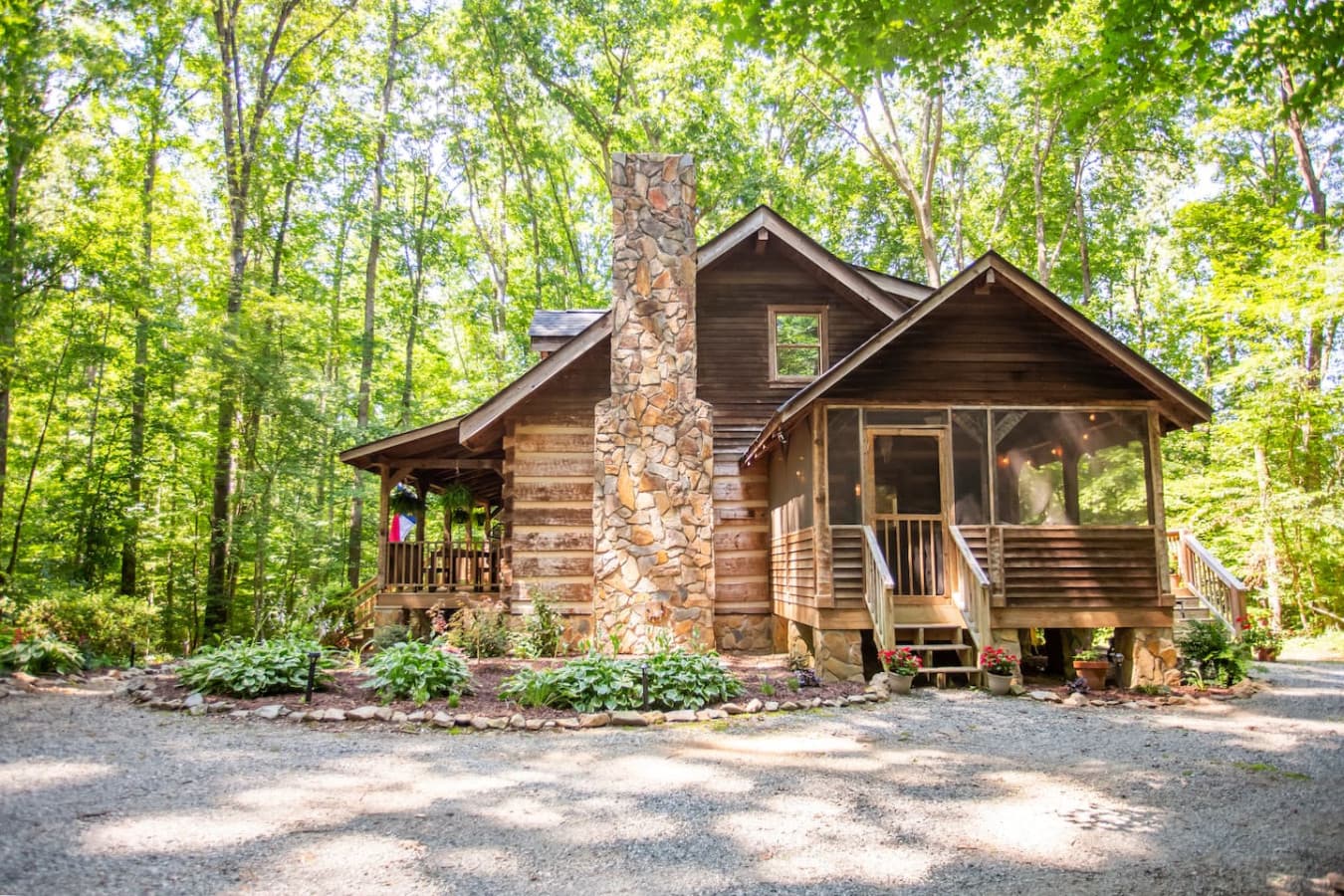 A stately stone chimney stands proud, crowning this inviting woodland escape.