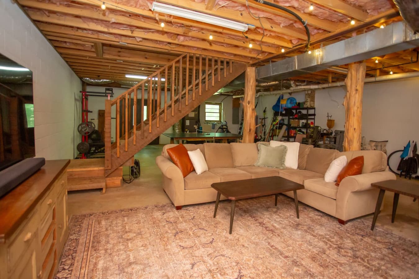 Comfortable seating and warm vibes create the perfect hangout spot downstairs.