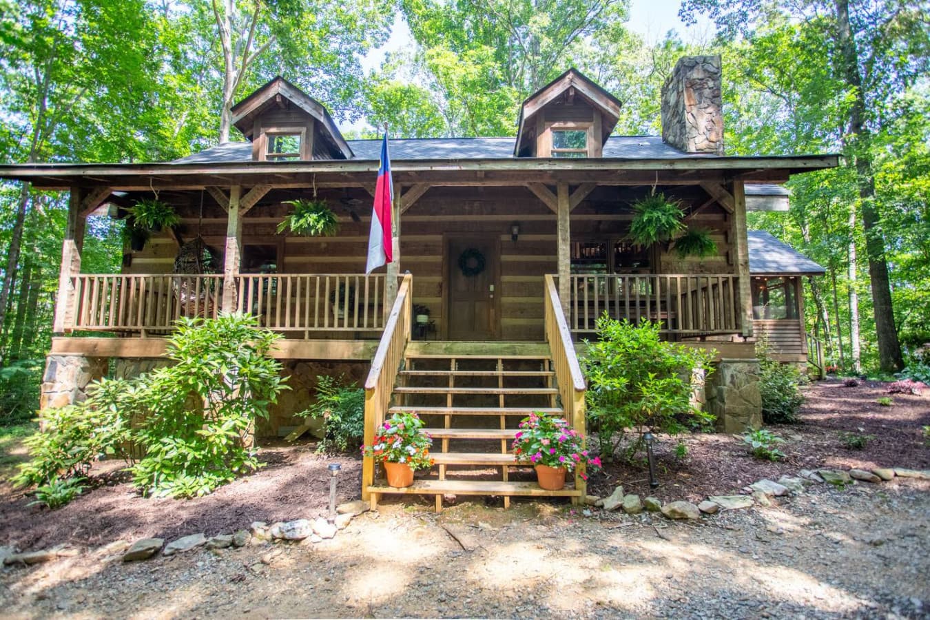 An inviting entry framed by nature’s beauty and warm cabin tones.